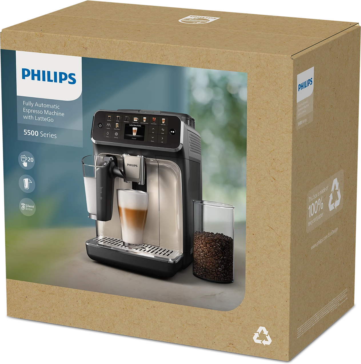 Une machine à expresso Philips dans une boîte. La machine est noire et argentée, avec un verre de café et de lait. Grains de café dans un verre.