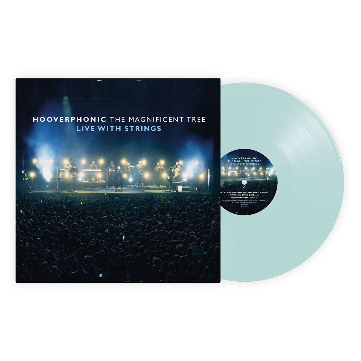 Albumhoes en vinylplaat. De hoes toont een live concert met een band en orkest. Het vinyl is lichtblauw van kleur.