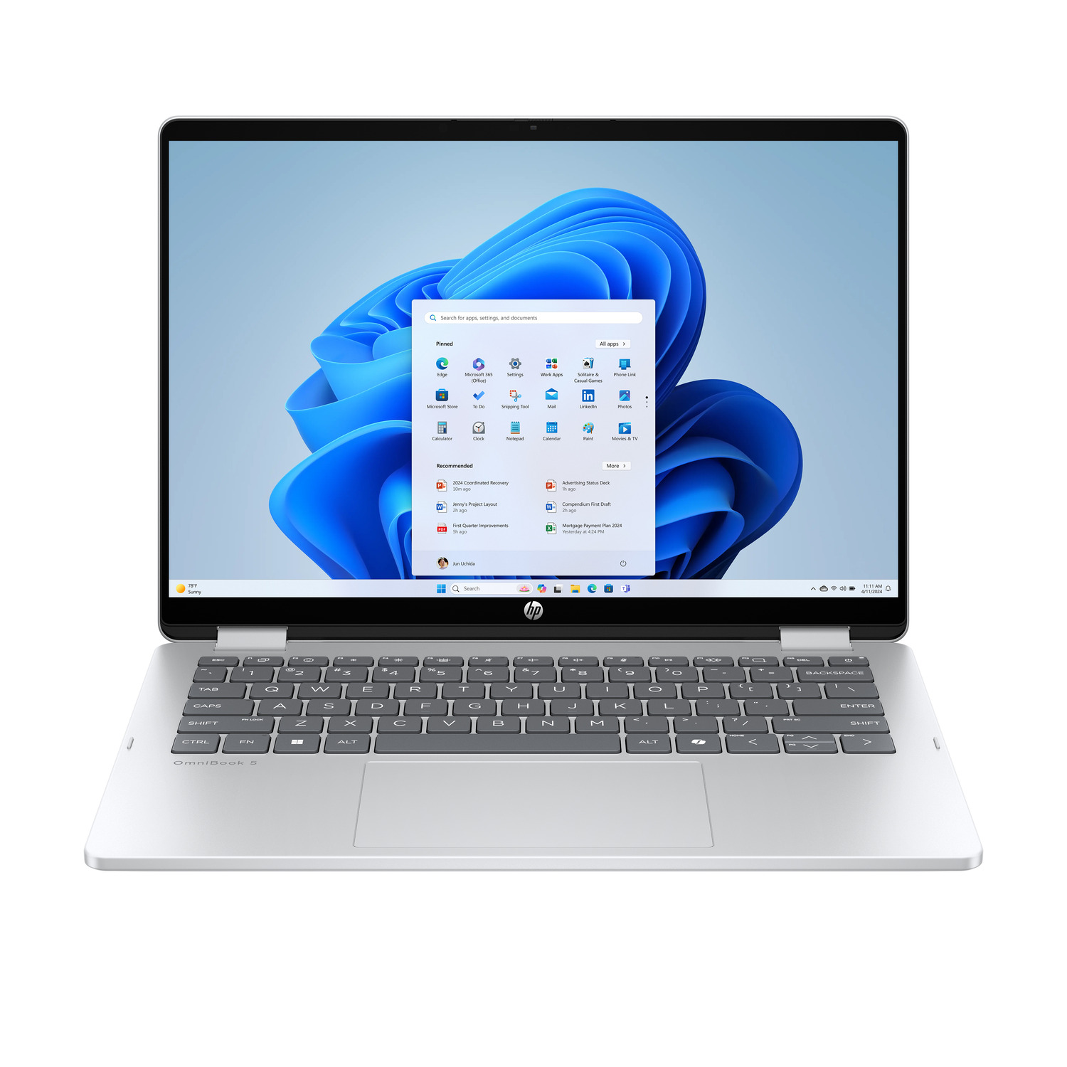 Silver HP OmniBook 5 laptop open, showing Windows 11 interface. Keyboard visible. Screen displays apps and settings options.