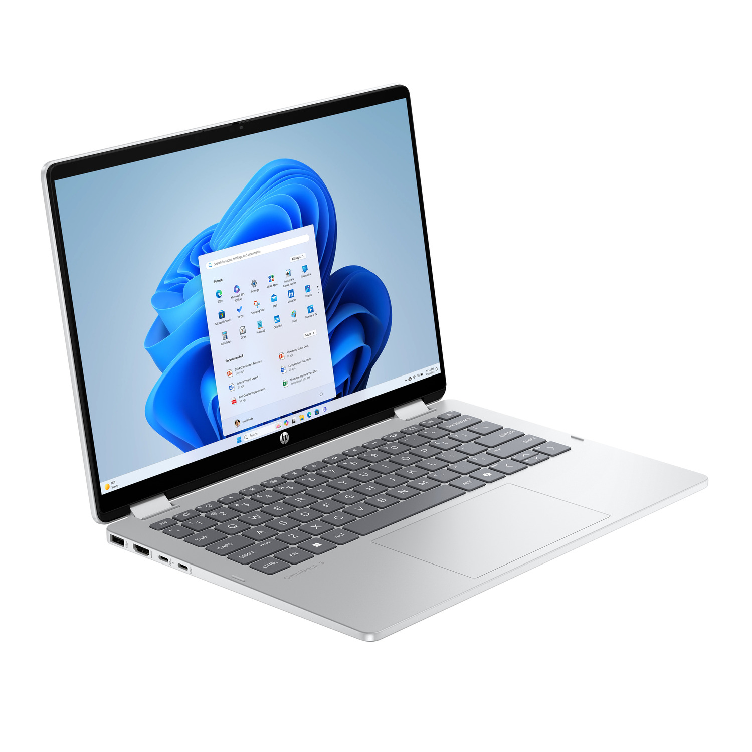 A silver HP laptop is open, displaying the Windows 11 interface. The screen shows app icons and a blue background.