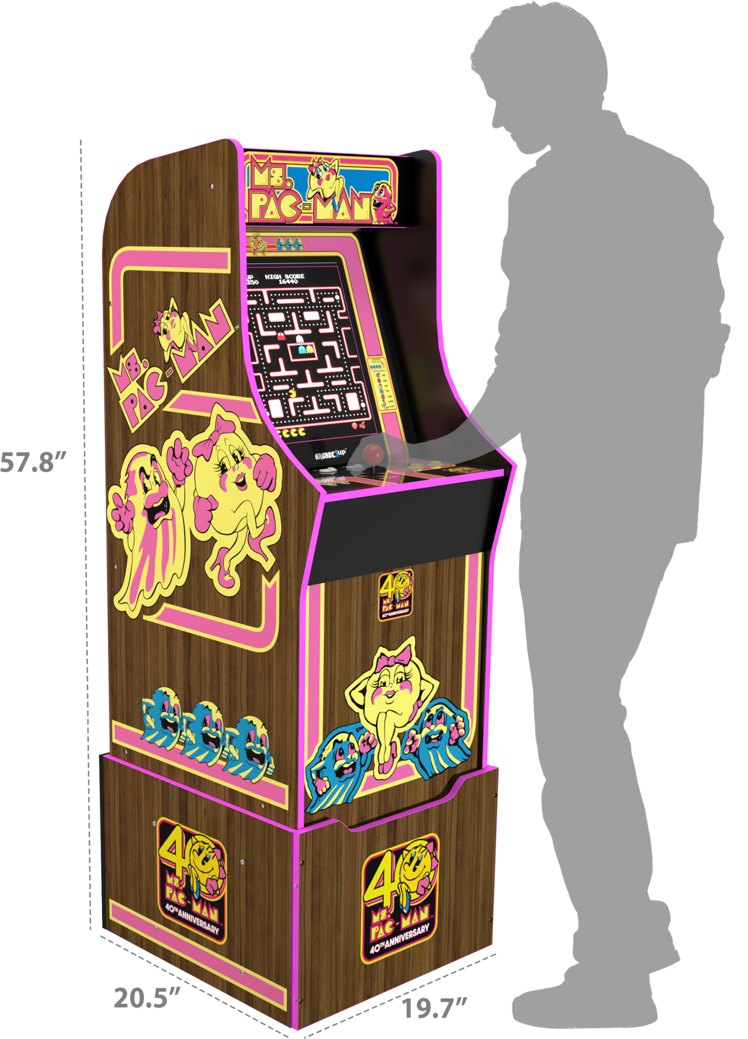 Egy személy a Ms. Pac-Man arcade gép mellett áll. A gép faerezetes felületű és Ms. Pac-Man grafikákkal rendelkezik.