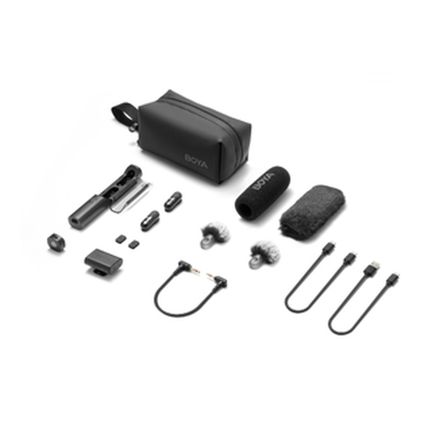 An assortment of black audio equipment, including a case, microphones, cables, and connectors, laid out on a white surface.
