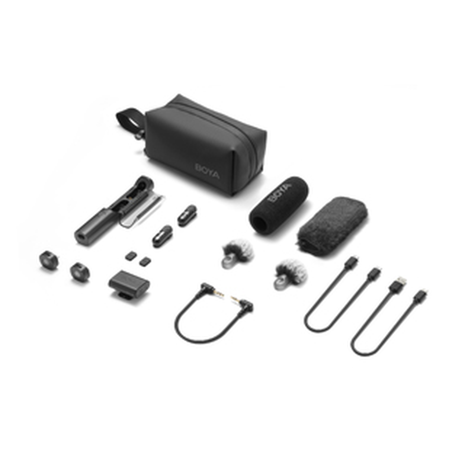 A collection of black audio equipment, including a bag, microphones, cables, and small adapters, arranged on a white surface.