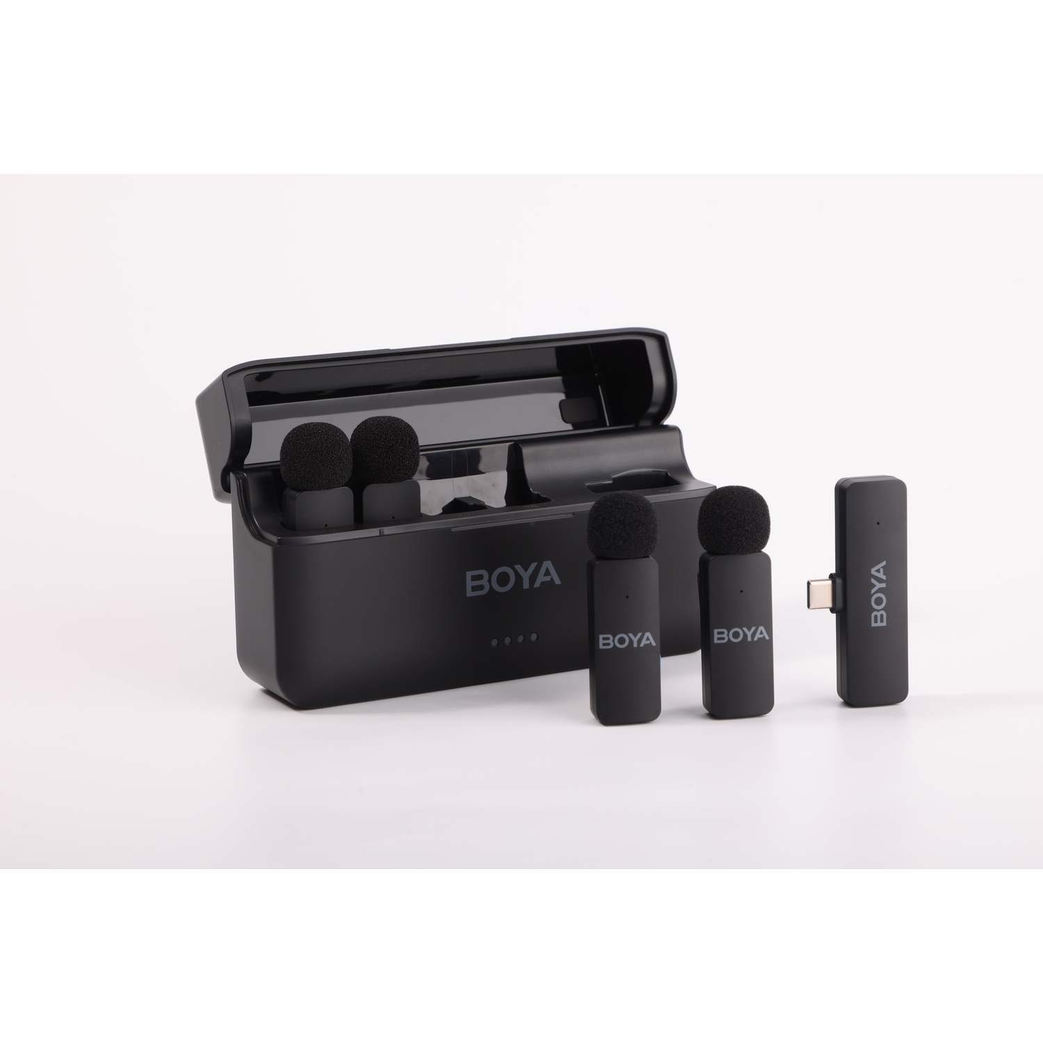 Black BOYA wireless microphone set. Includes a charging case, microphones, and a receiver. All on a white background.