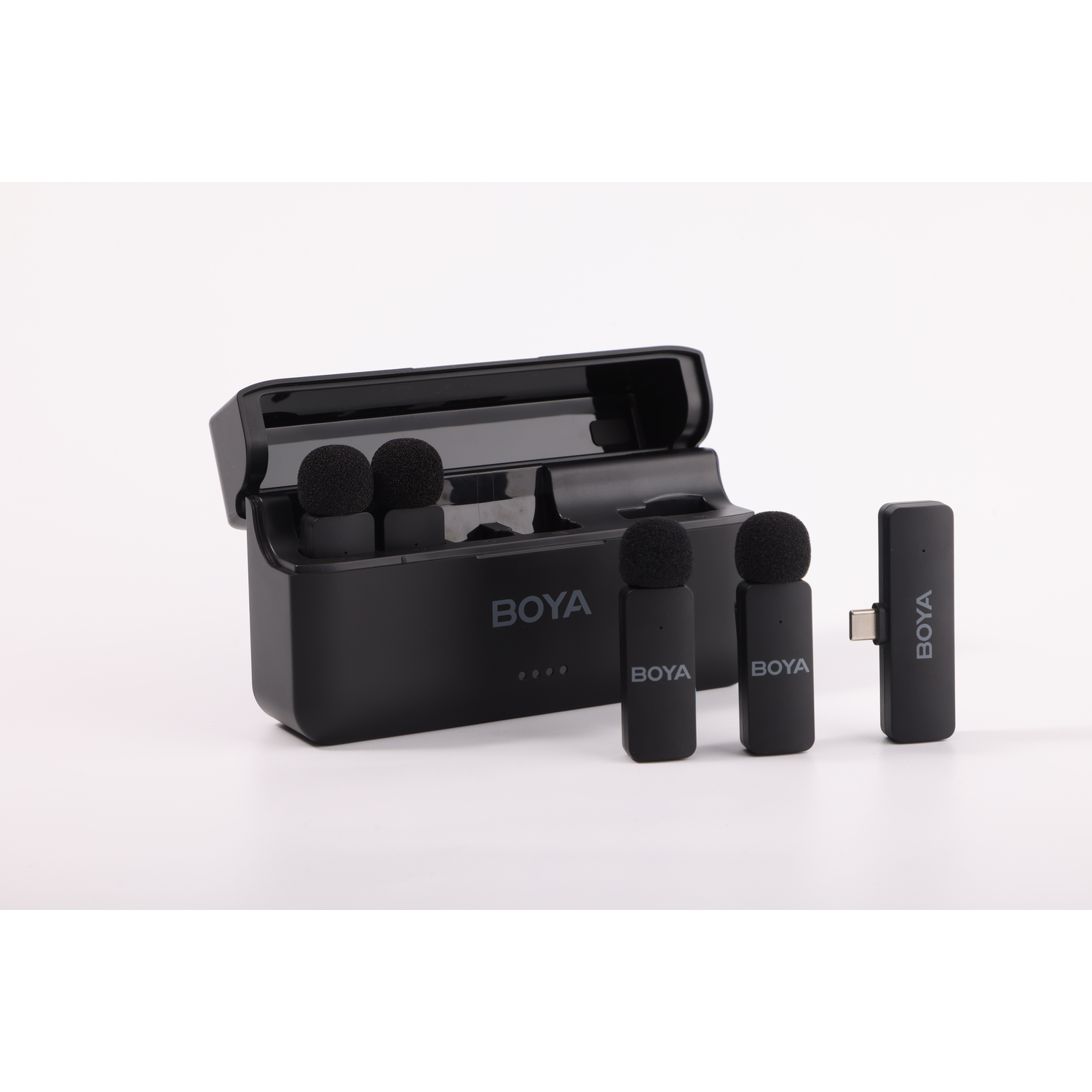 A black BOYA microphone set is displayed. It includes a charging case, three microphones, and a receiver, all against a white background.