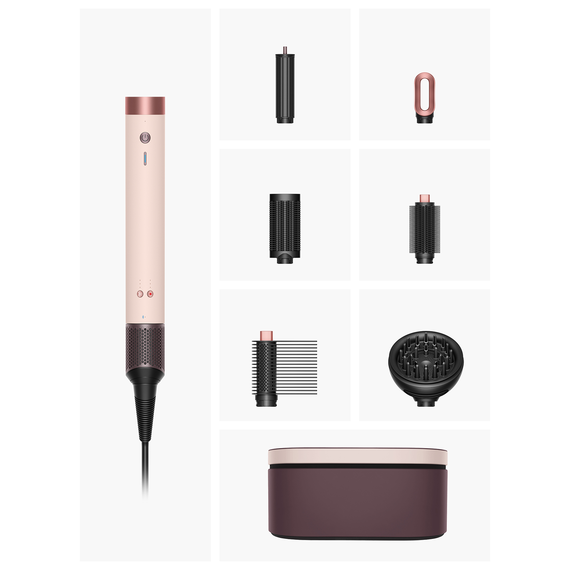 Prezentowany jest styler do włosów i jego nasadki. Styler jest różowy i miedziany. Nasadki obejmują szczotki i dyfuzor.