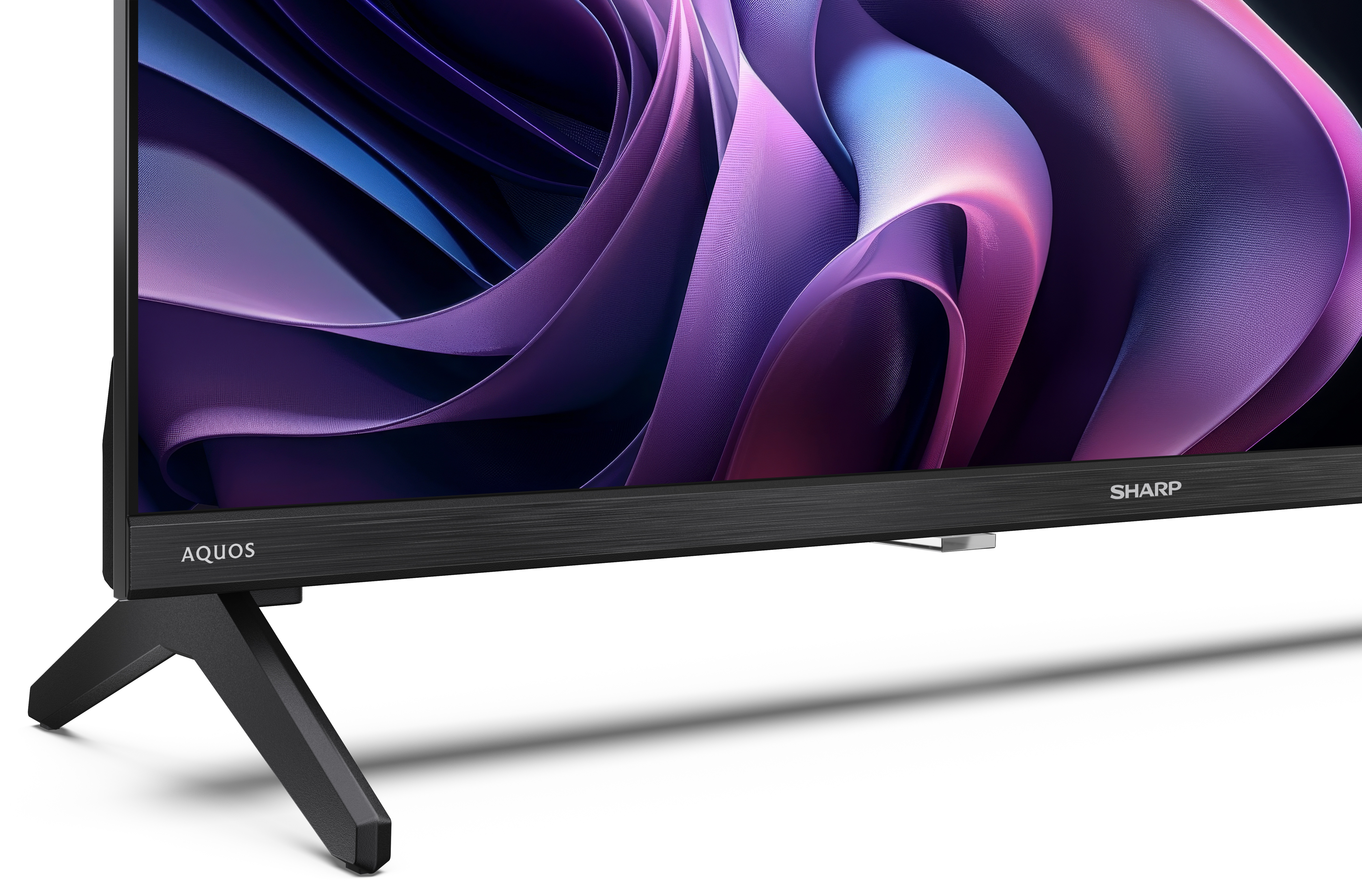 Czarny telewizor Sharp Aquos z fioletowym abstrakcyjnym wzorem na ekranie i czarną podstawą.