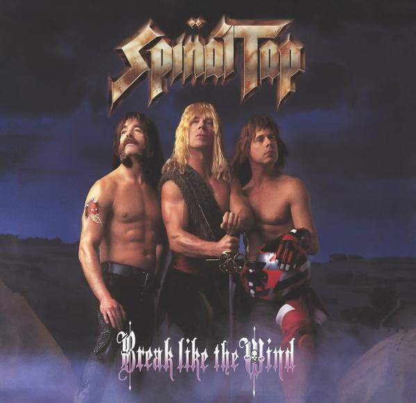 Spinal Tap Bandmitglieder, oberkörperfrei mit Schwertern und Helmen, stehen vor einer Landschaft. Der Albumtitel 'Break Like the Wind' steht unten.