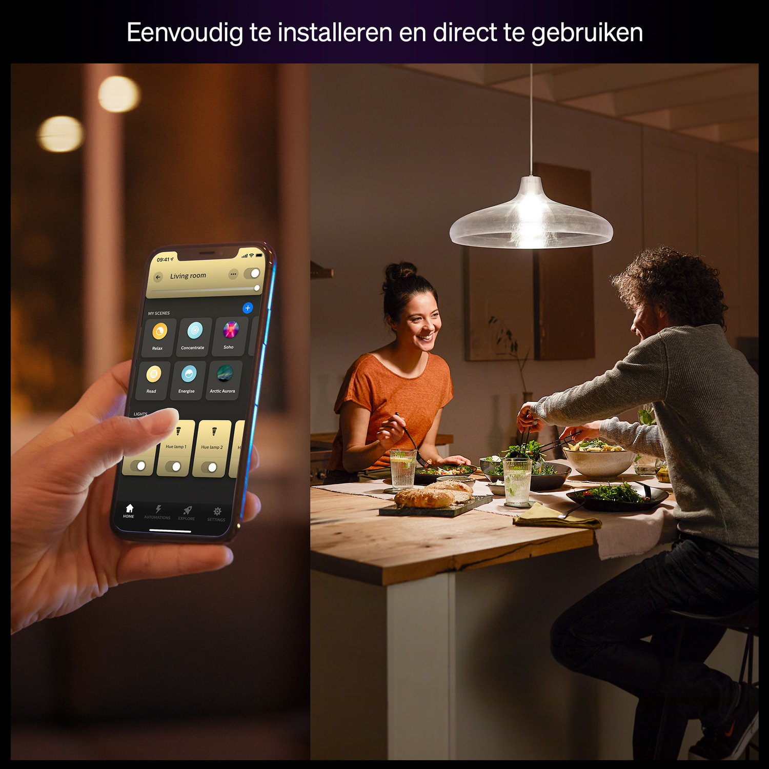 A person using a smartphone to control lights, while two people are eating dinner at a table. A hanging light is above them.