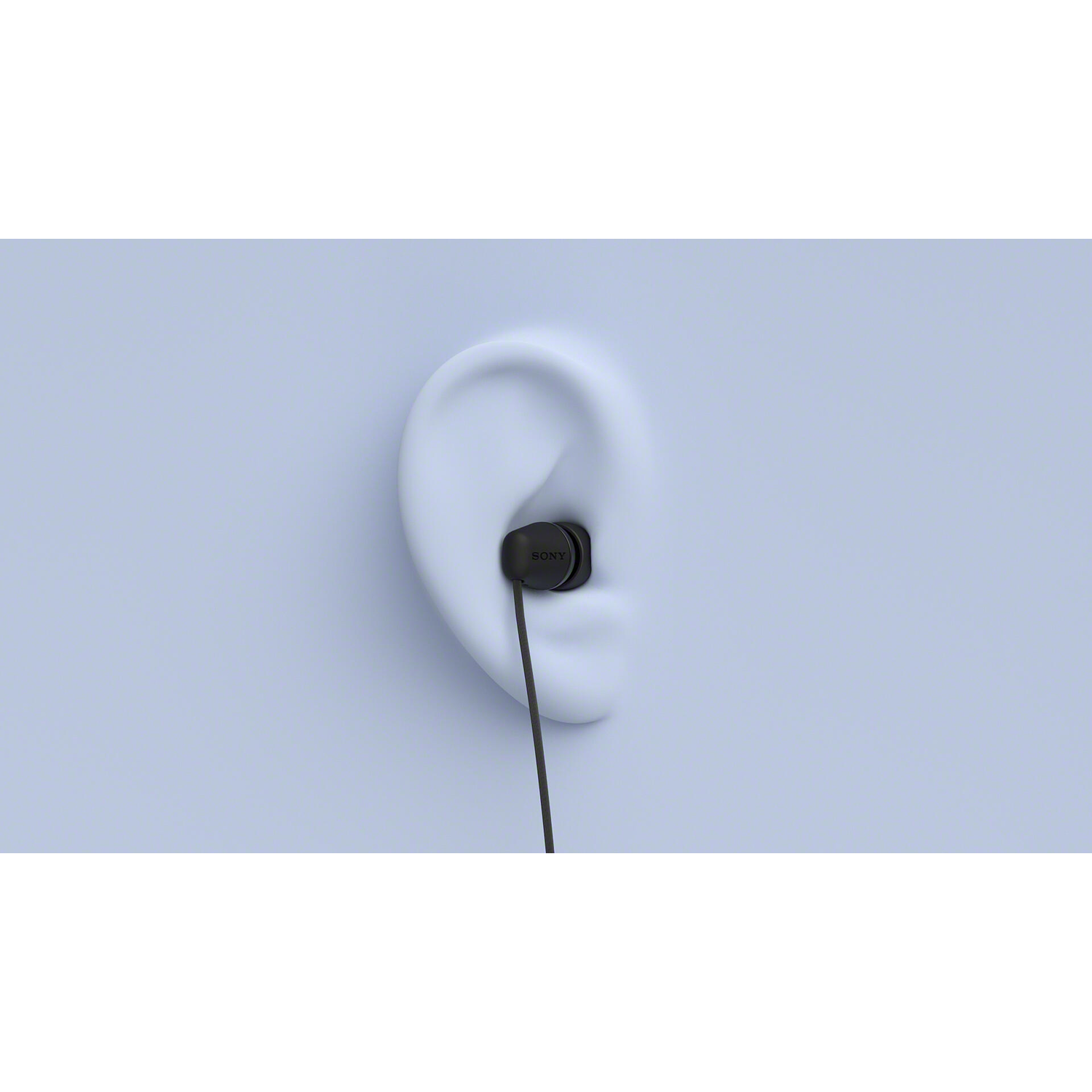 A black earbud is placed inside an ear-shaped mold. The earbud's wire extends downwards against a light blue background.