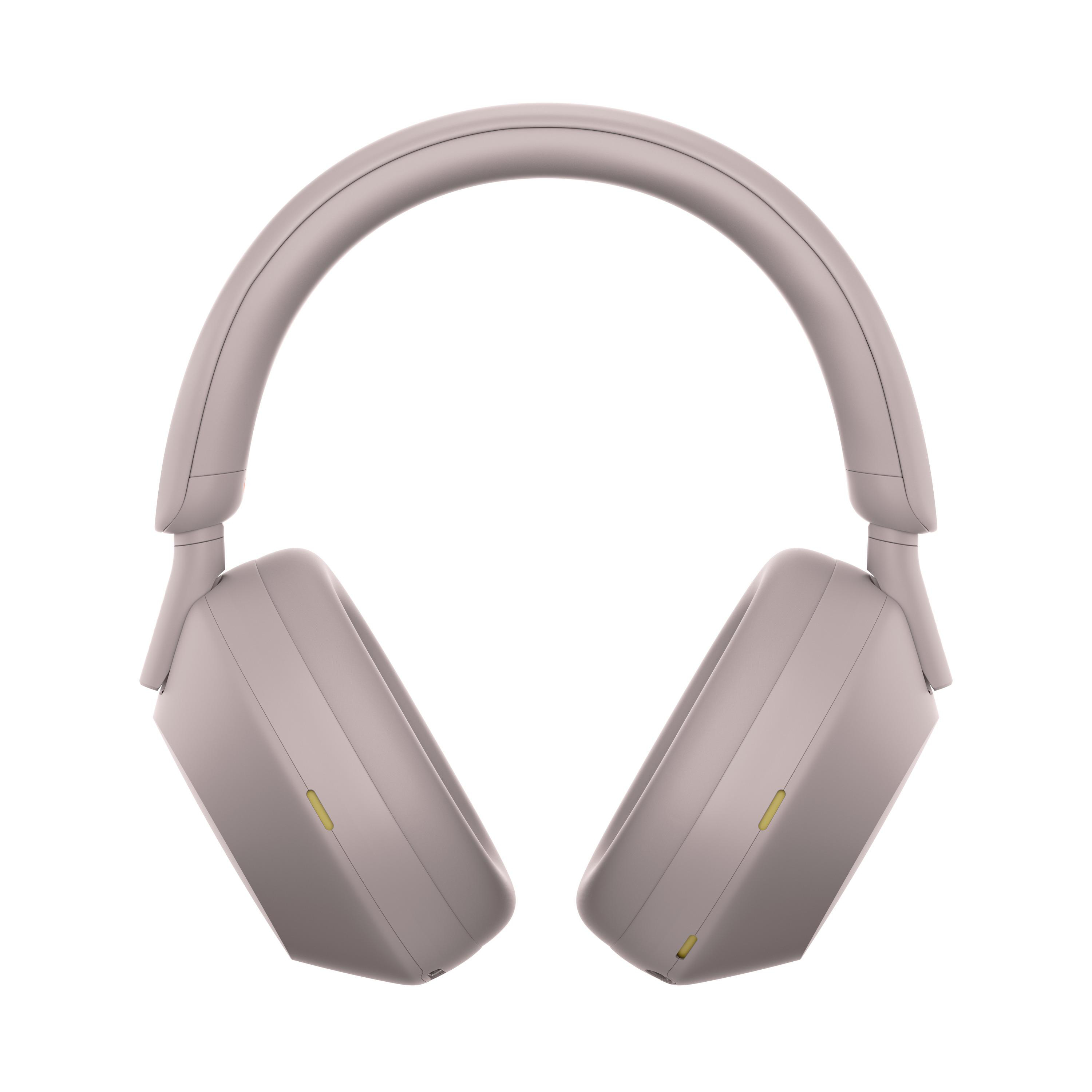 Over-Ear-Kopfhörer, hellviolett. Ohrmuscheln quadratisch. Gelber Knopf am Ohrmuschel. Weißer Hintergrund.