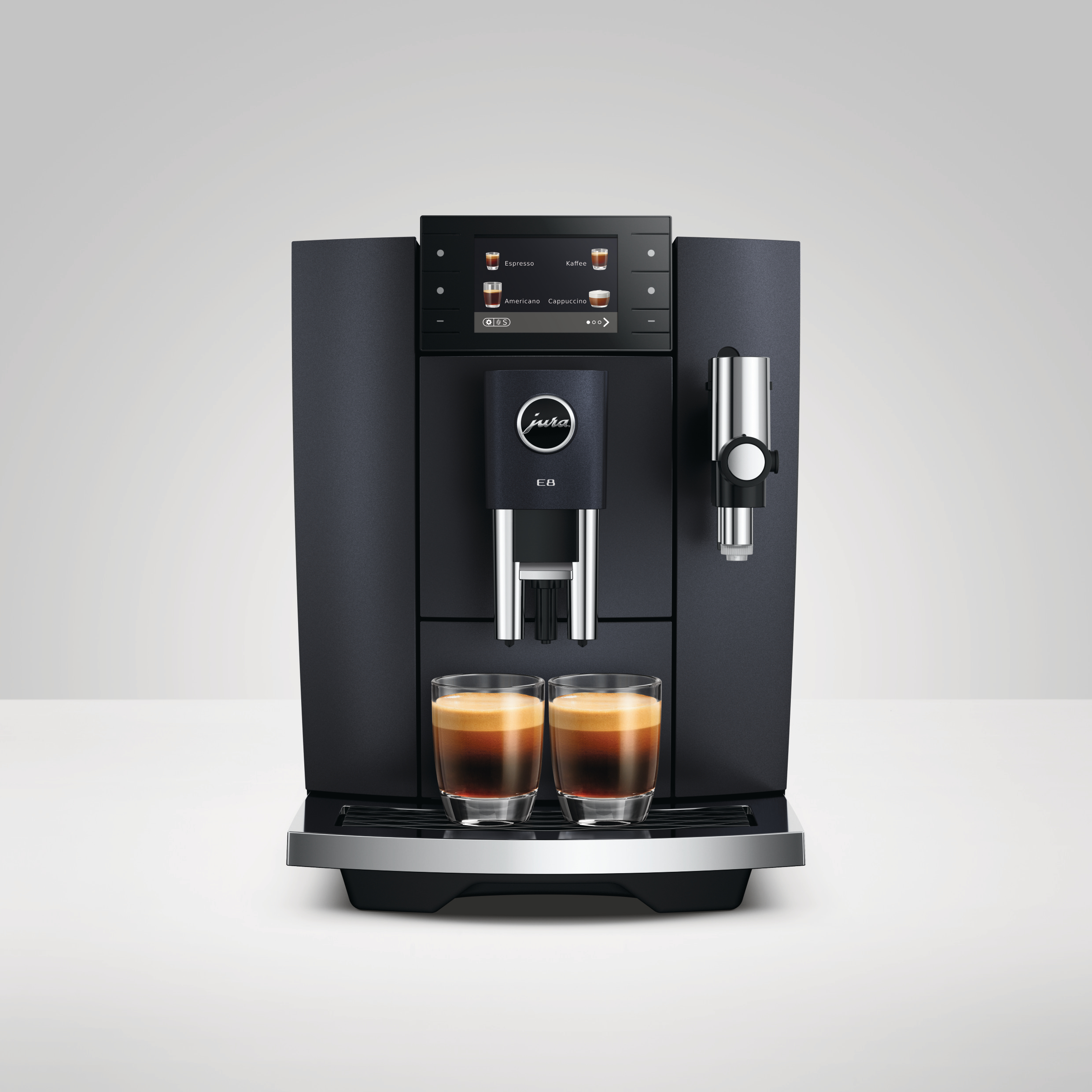 Eine schwarze Jura E8 Kaffeemaschine mit zwei Espressi in Gläsern. Die Maschine hat ein digitales Display.
