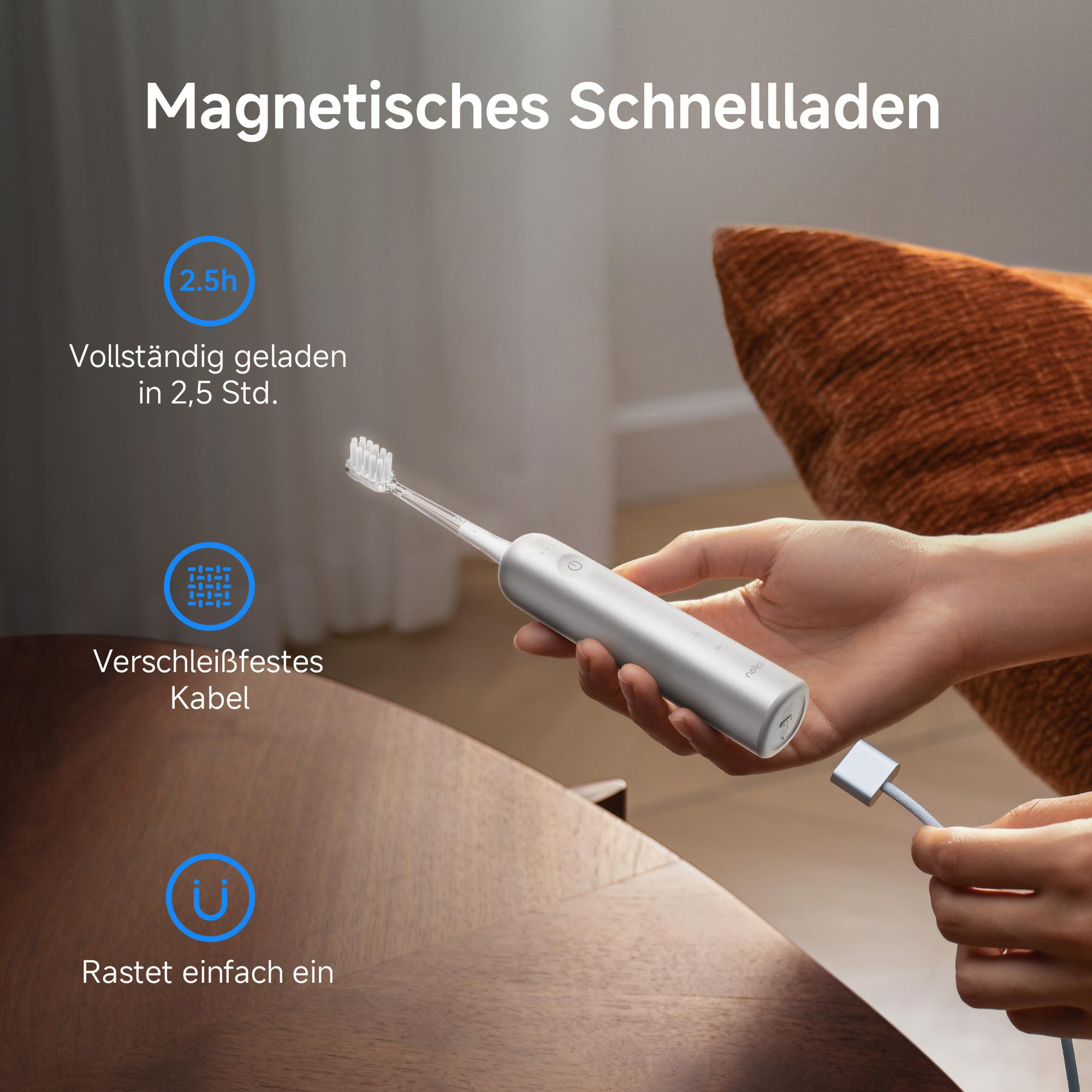 Eine Person hält eine silberne Zahnbürste, die mit einem Ladekabel verbunden ist. Auf dem Bild steht 'Magnetisches Schnellladen'.