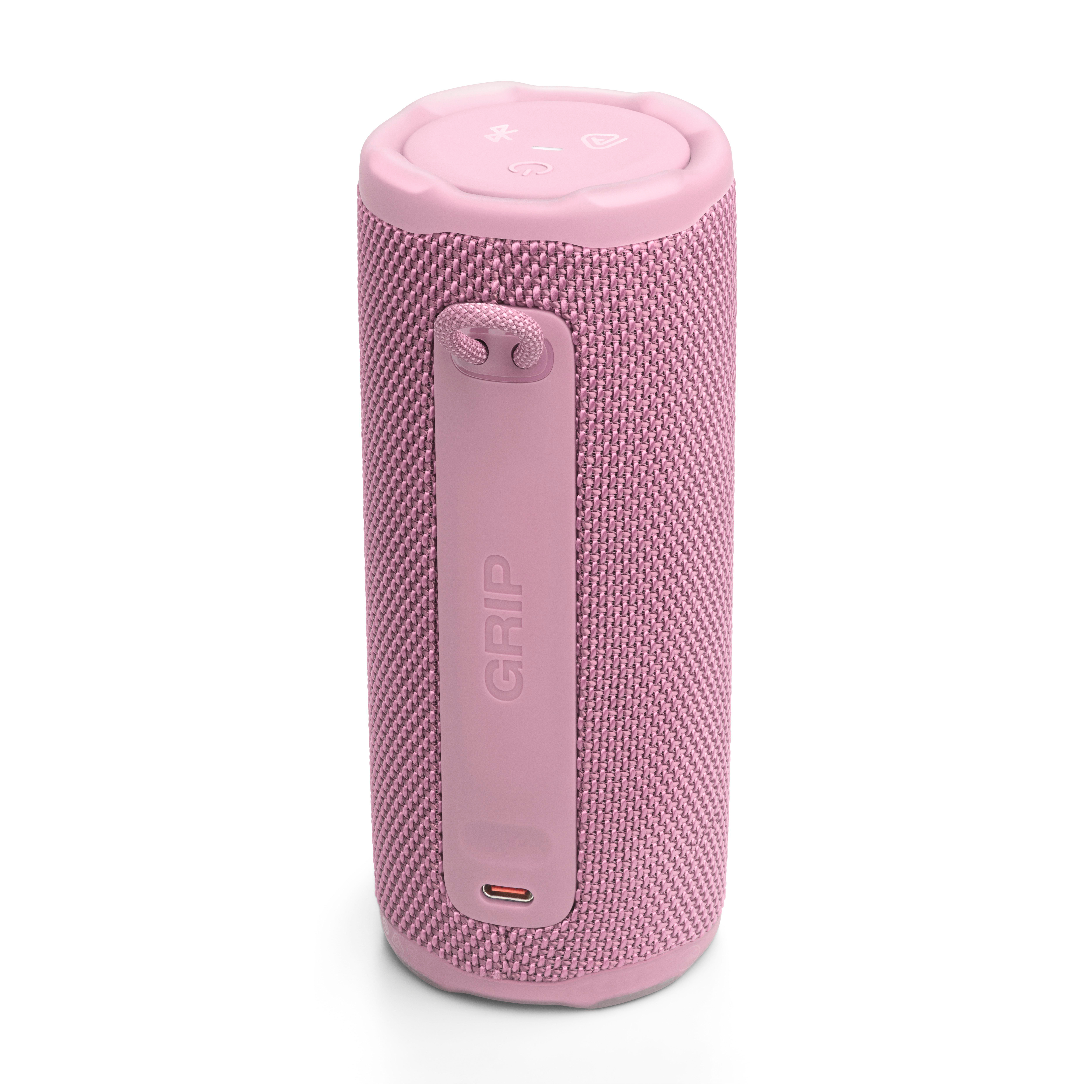 Ein rosa zylindrischer Lautsprecher mit Stoffstruktur. Er hat einen Riemen mit dem Wort 'GRIP' und Bedientasten.