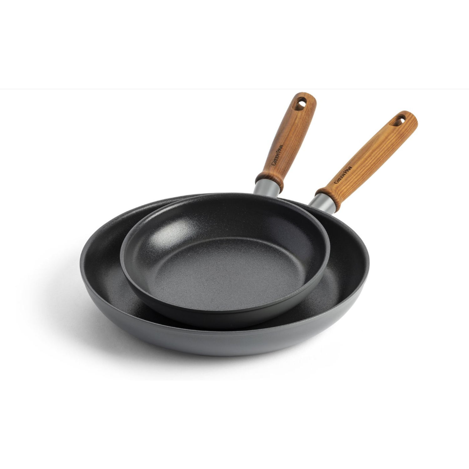 Two black frying pans, one inside the other, with wooden handles. The background is plain white.