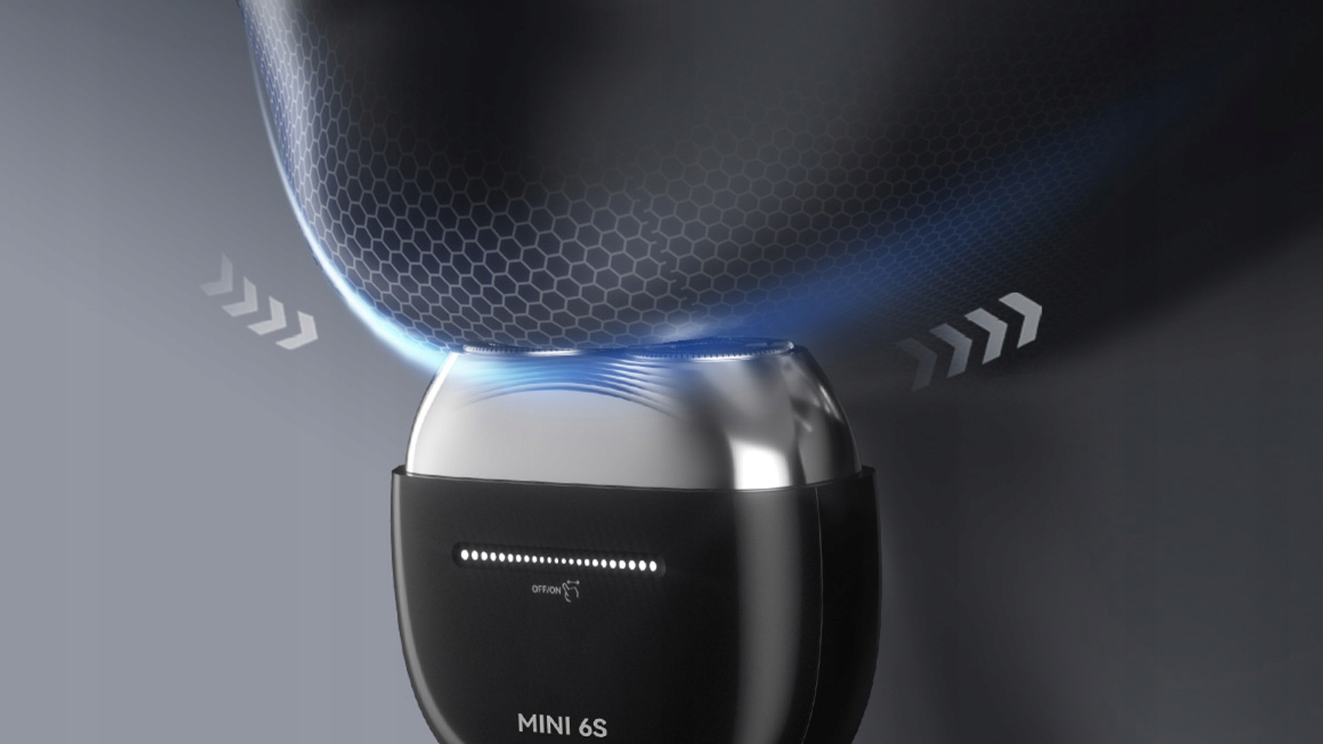 Zbliżenie czarnej i srebrnej golarki elektrycznej z podświetlanymi wskaźnikami zasilania. Strzałki i wzór sześciokątny w tle.