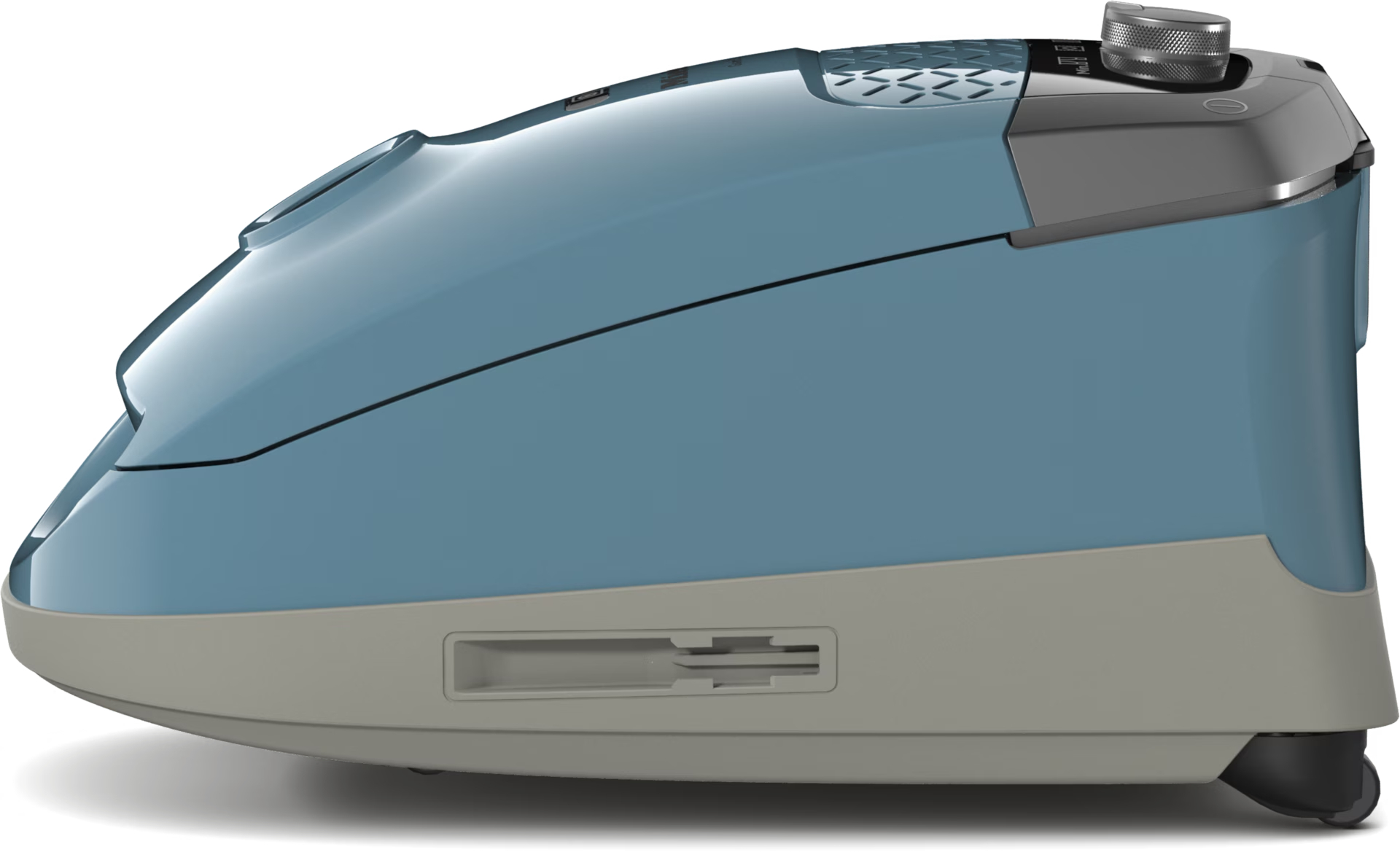 Vista lateral de una limpiadora a vapor azul y gris. Tiene un dial en la parte superior y una pequeña rueda en la parte inferior. La limpiadora está sobre una superficie blanca.