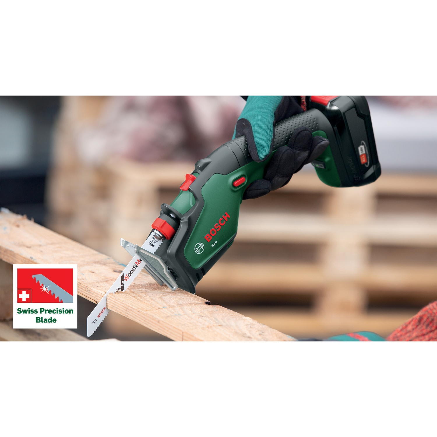 Una persona usa una sega Bosch verde e nera per tagliare un pezzo di legno. La sega ha una lama di precisione svizzera.