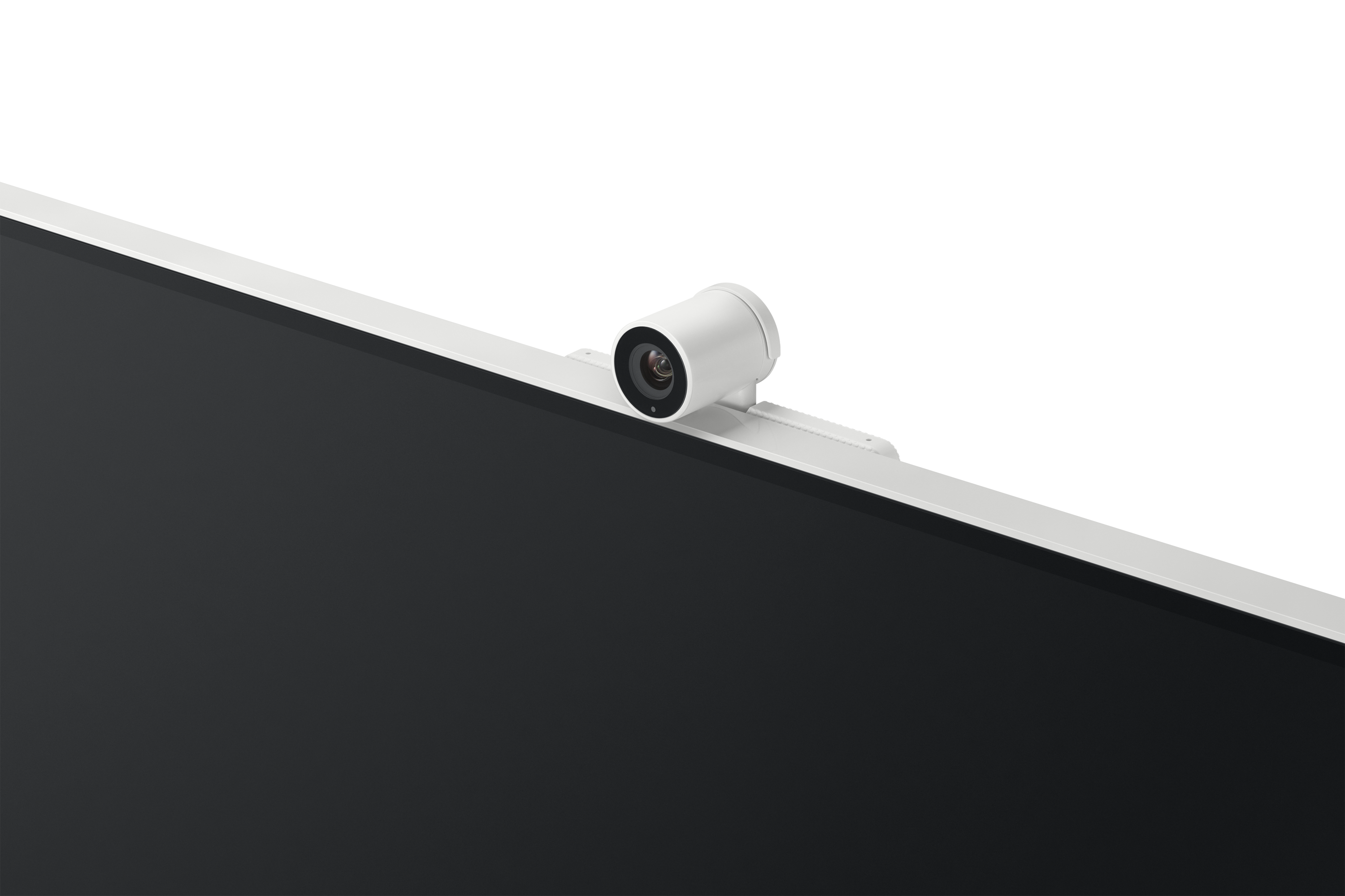 Biała kamera internetowa jest zamontowana na białym monitorze z czarnym tłem. Kamera ma obiektyw i jest ustawiona pod kątem.