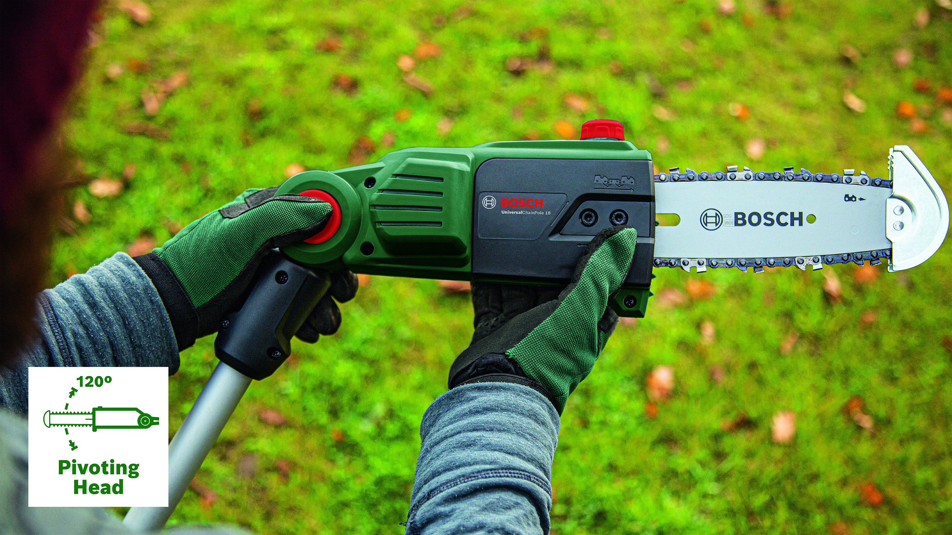 Una persona tiene in mano una motosega Bosch verde con una lama argentata. Lo sfondo è erba verde sfocata.