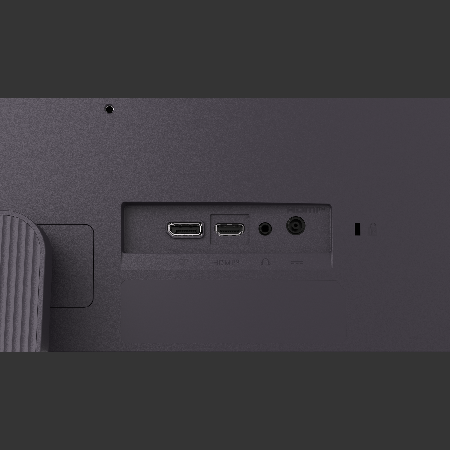 Close-up of a monitor's back with ports: HDMI, DP, and audio. The surface is dark gray.