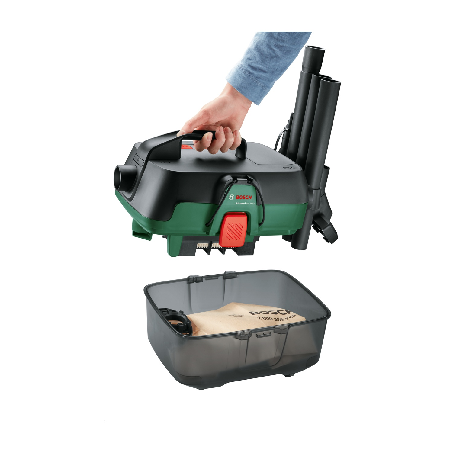 Una mano tiene in mano un aspirapolvere Bosch nero e verde. Sotto c'è un contenitore trasparente con un sacchetto marrone all'interno.