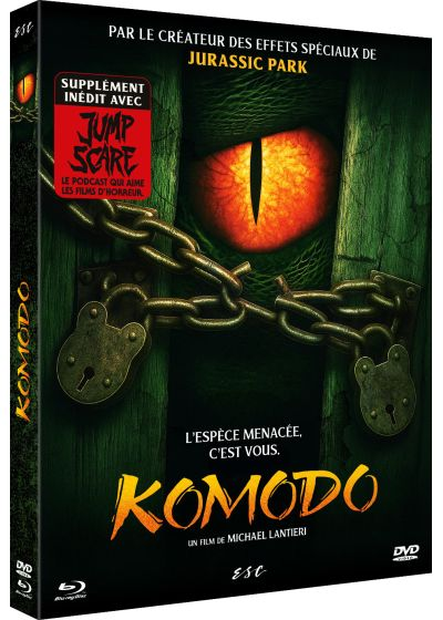 Een dvd-hoes toont een oog met een rode iris. Kettingen en hangsloten bevinden zich ervoor. De titel is 'Komodo'.