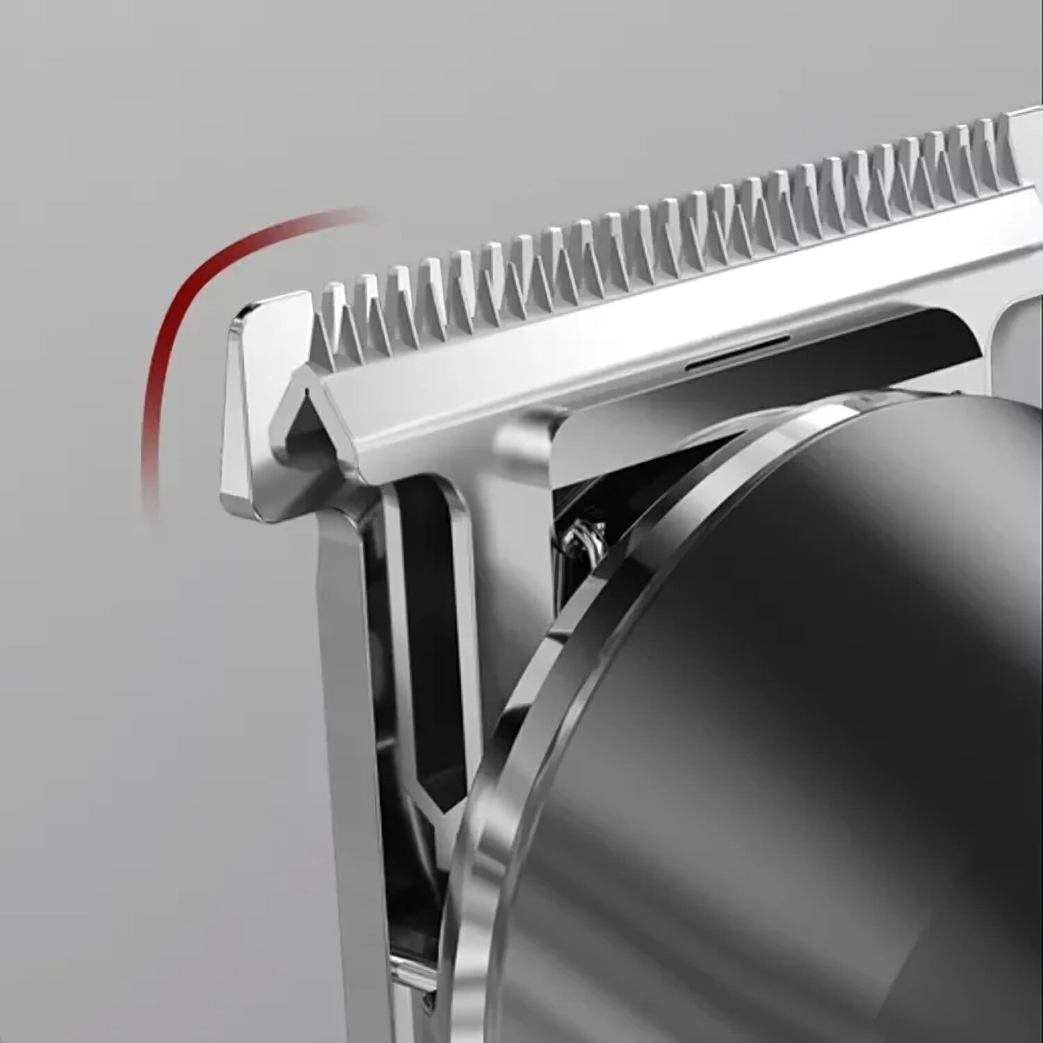 Zbliżenie srebrnego ostrza do strzyżenia włosów. Ostrza są ostre i szczegółowe, z czerwonym łukiem z boku. Tło jest szare.