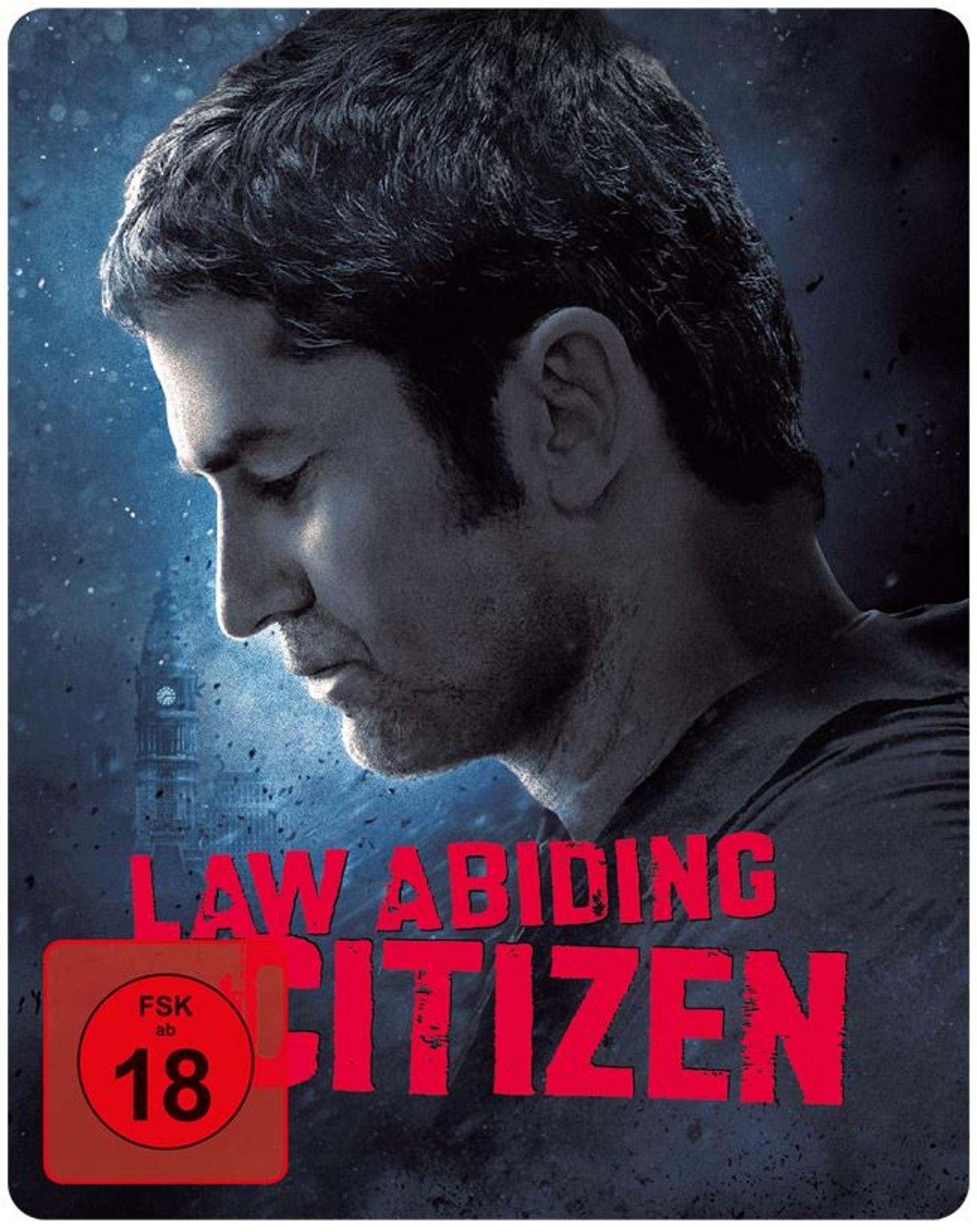 Filmposter für 'Law Abiding Citizen'. Ein Profil eines Mannes ist zu sehen, mit Text und einer '18'-Bewertung. Im Hintergrund ist ein Gebäude zu sehen.