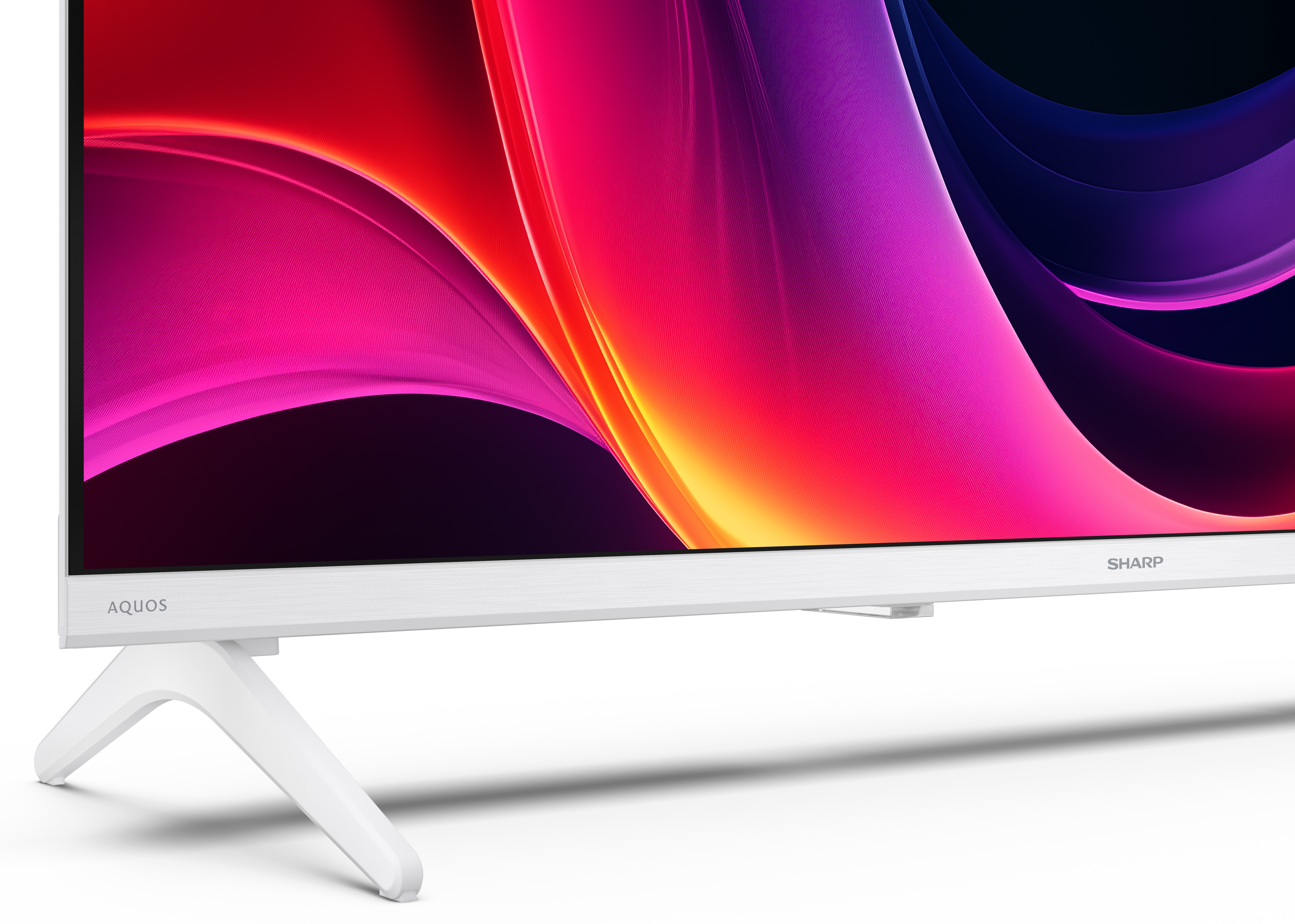 Biały telewizor Sharp Aquos z kolorowym, abstrakcyjnym wyświetlaczem. Biała podstawa, widoczne słowo 'SHARP'.