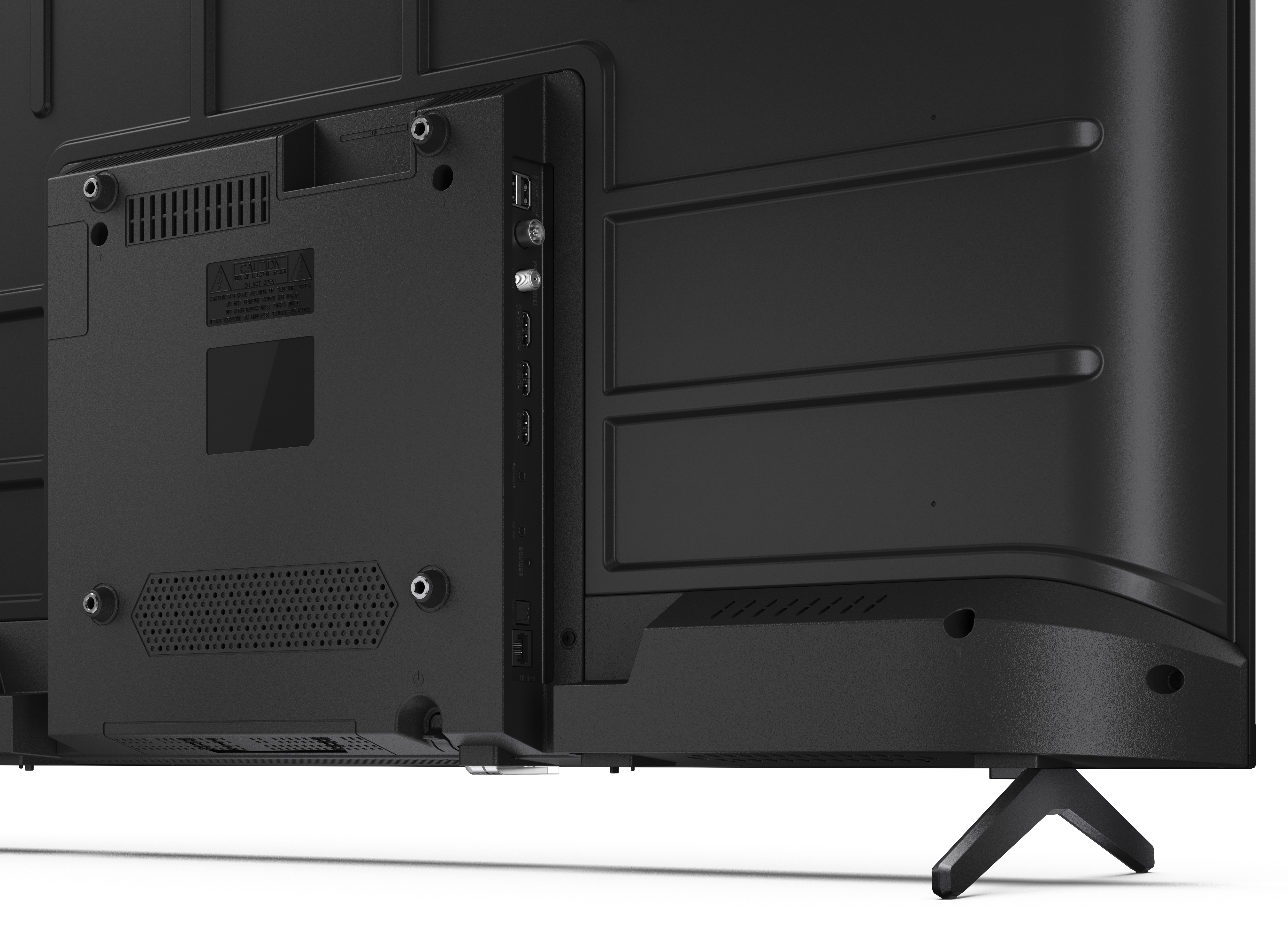 Tył czarnego telewizora. Zawiera porty, etykietę ostrzegawczą i stojak. Widoczne są różne połączenia. Stojak jest trójkątny.
