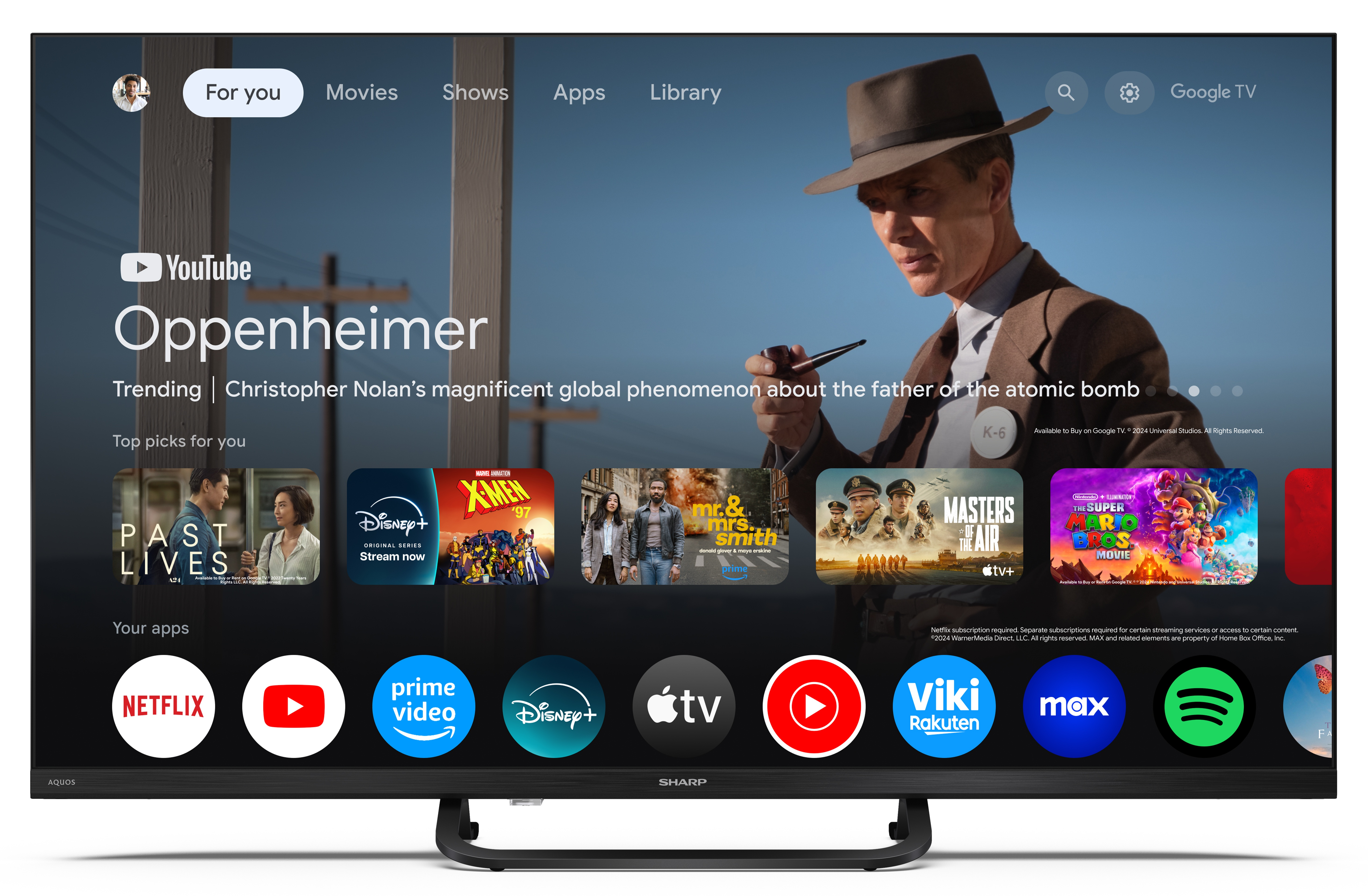 Telewizor Sharp wyświetla ekran główny YouTube z filmem Oppenheimer i ikonami aplikacji, takimi jak Netflix i Disney+.