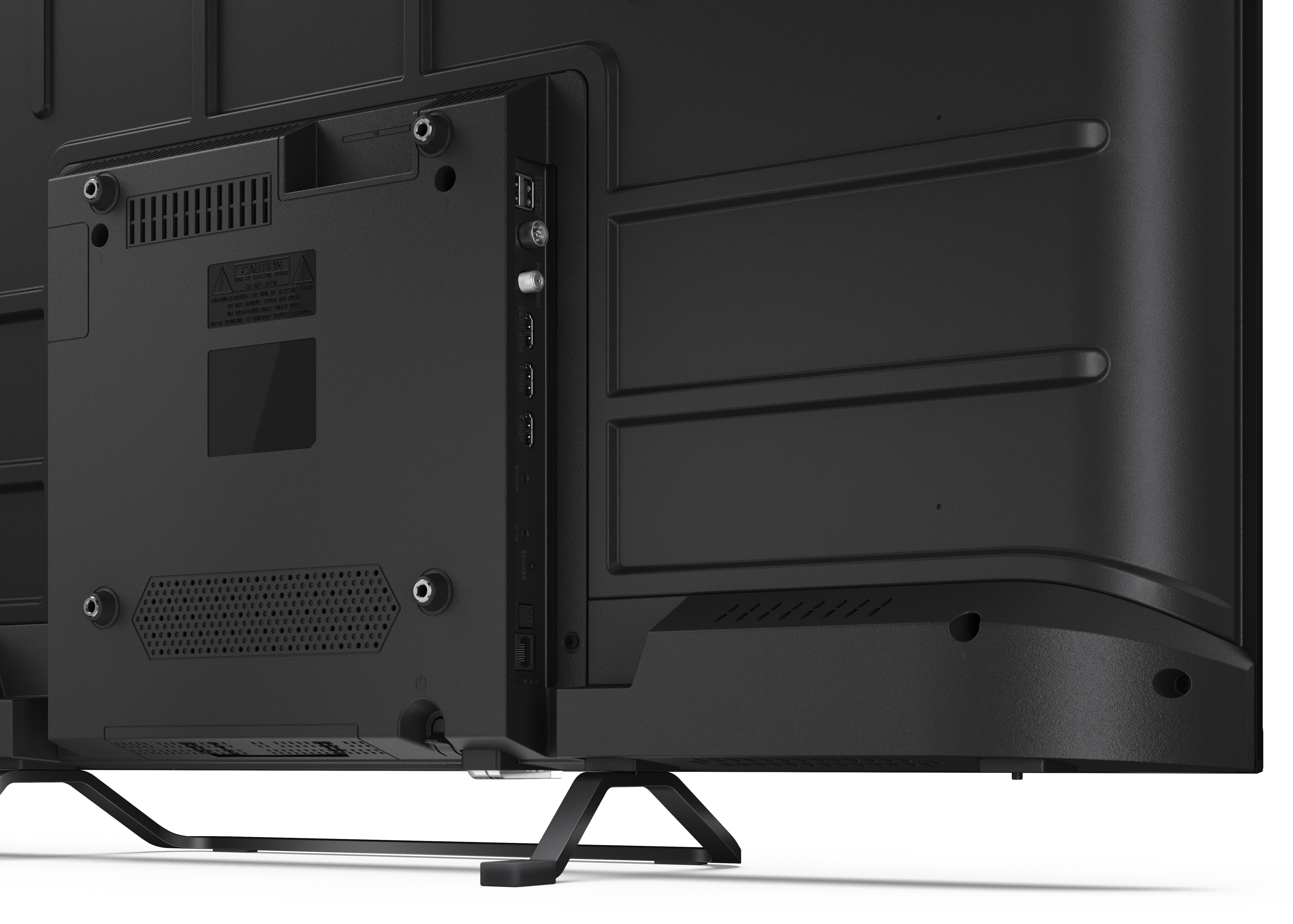 Tył czarnego telewizora z portami, otworami wentylacyjnymi i etykietą ostrzegawczą. Czarny stojak go wspiera.