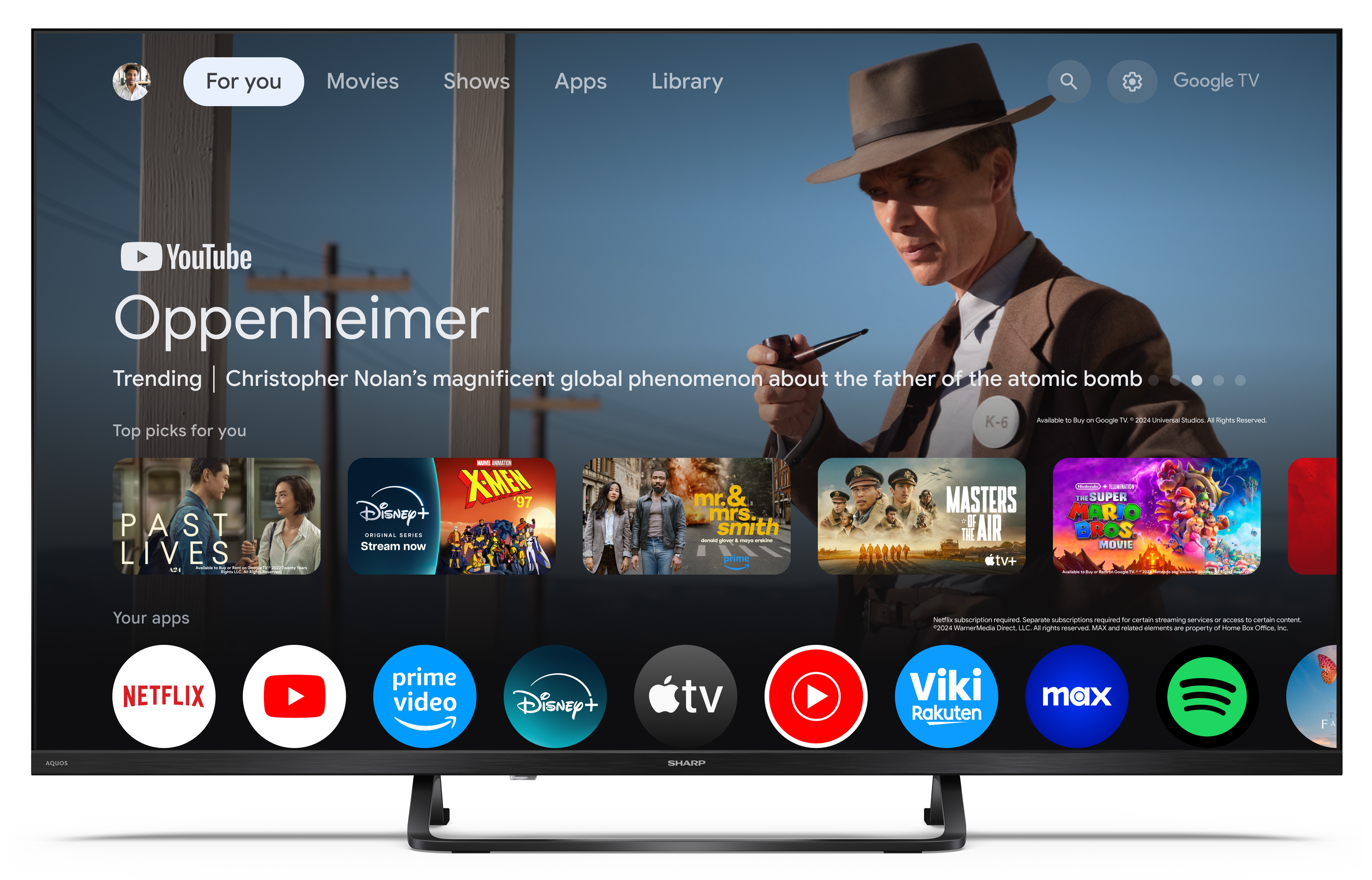 Ekran telewizora wyświetla film Oppenheimer z YouTube. Widoczne są aplikacje takie jak Netflix, Prime Video i Disney+.