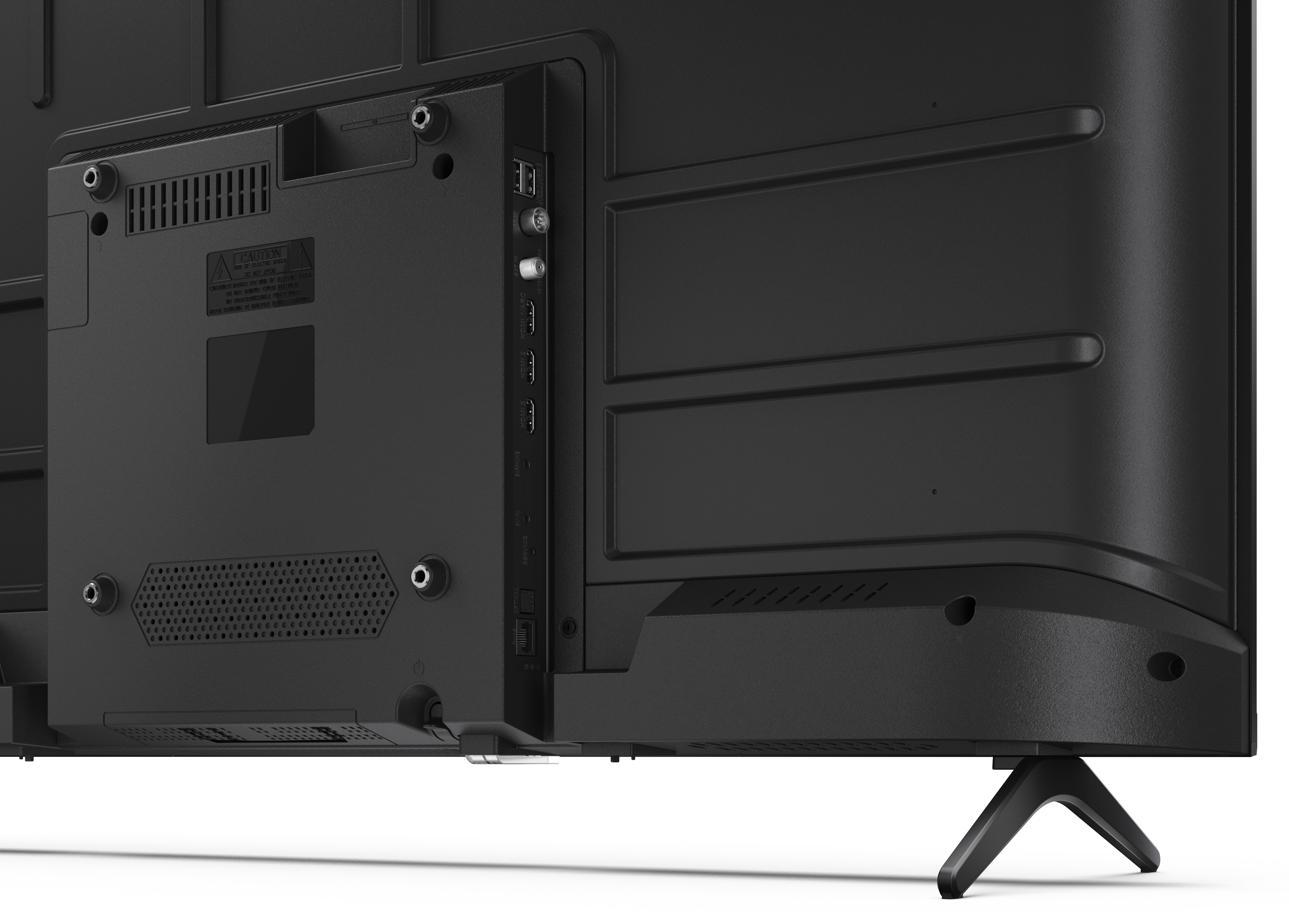 Zbliżenie tylnej części czarnego telewizora z portami i wentylacją. Widoczna etykieta ostrzegawcza.