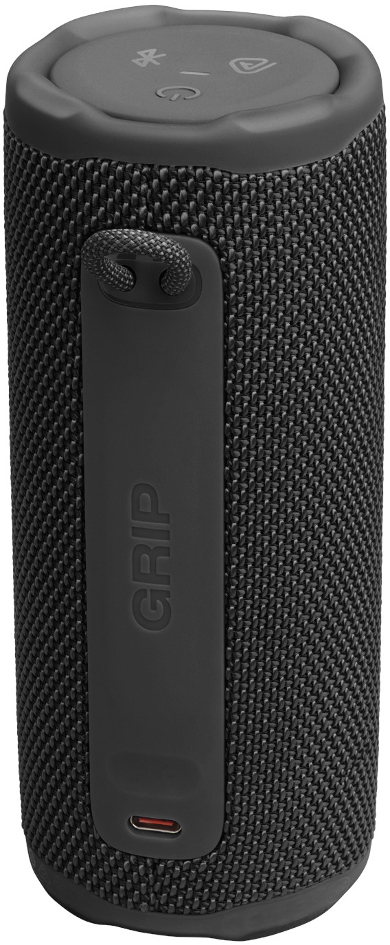Une enceinte Bluetooth noire et cylindrique avec une surface texturée. Elle possède des boutons de commande sur le dessus et une poignée latérale.