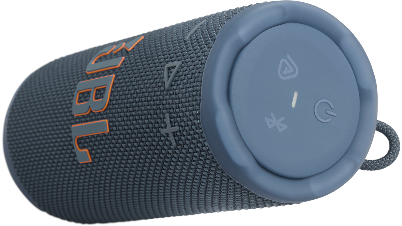 Un haut-parleur JBL teal. Il a le logo JBL en orange, des boutons de volume et un bouton d'alimentation. Une boucle de sangle est visible.