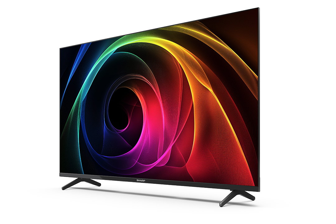A Sharp TV színes, absztrakt dizájnt jelenít meg. A TV fekete, fekete lábakkal, fehér háttér előtt.