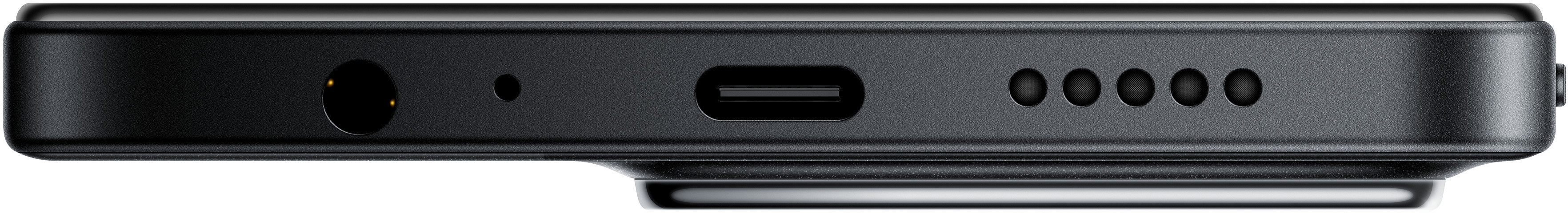 Zbliżenie dolnej krawędzi czarnego urządzenia. Widoczne gniazdo słuchawkowe, mikrofon, port USB-C i kratki głośnika.