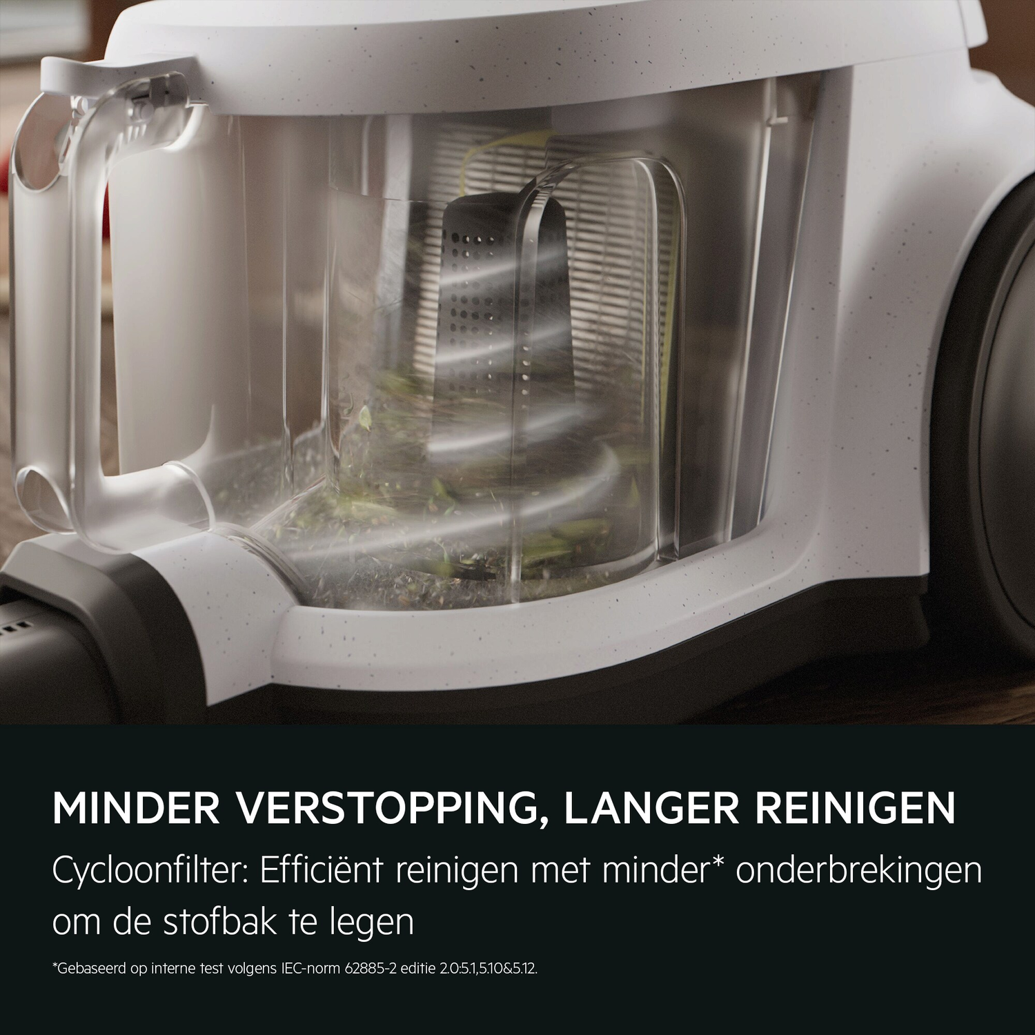 Close-up of a vacuum cleaner's dust container, showing a clear, transparent chamber with debris inside. The design focuses on efficiency and less clogging.