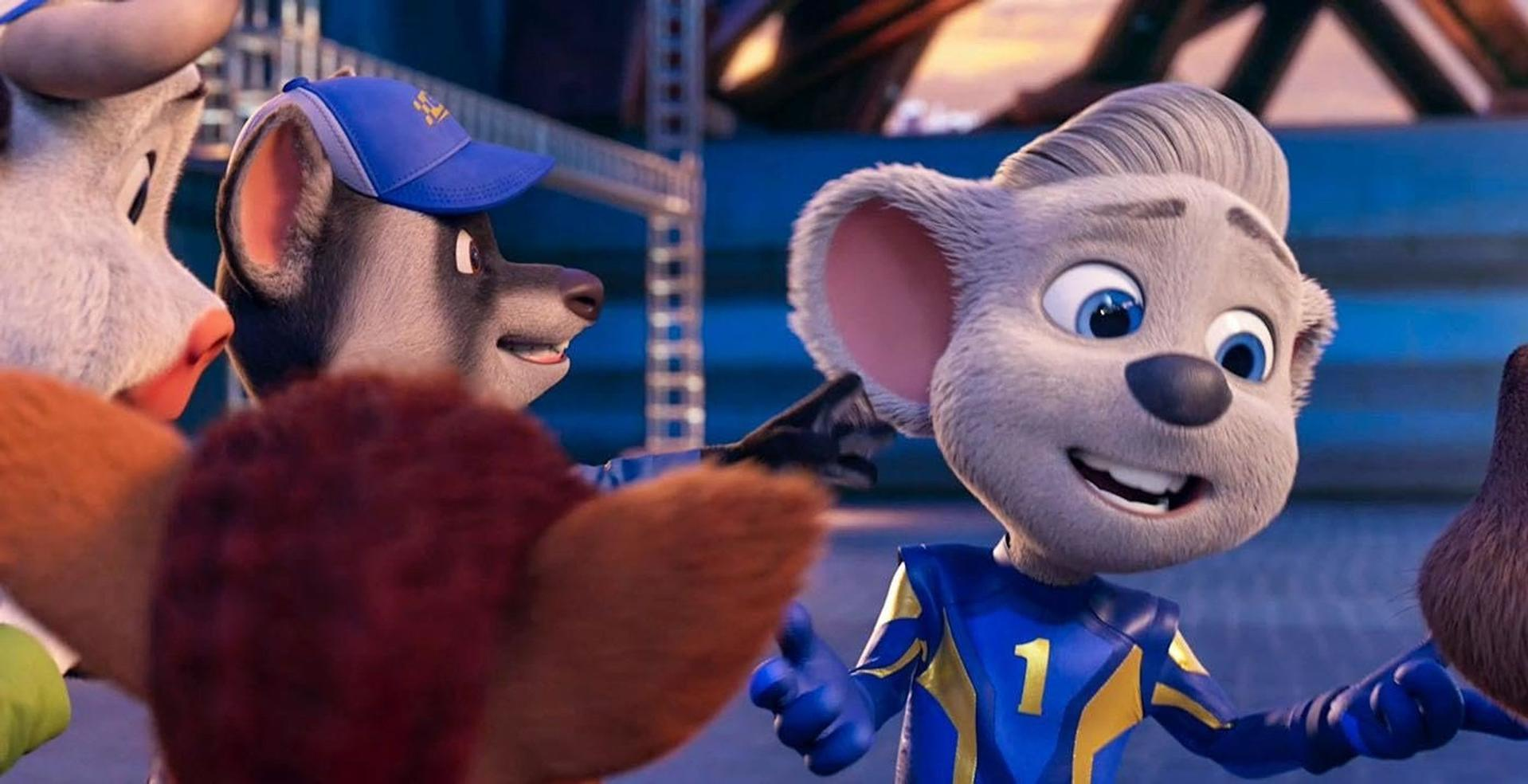 Animierte Charaktere, darunter eine Maus, ein Dachs und andere, lächeln. Die Maus trägt eine blau-gelbe Sportuniform. Die Szene hat einen Stadionhintergrund.