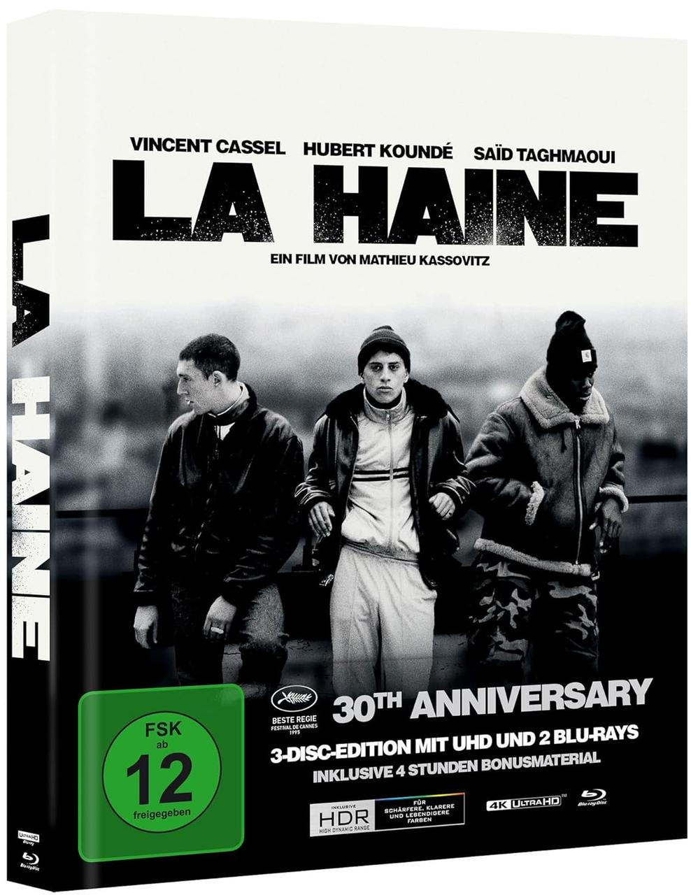 Filmcover von 'La Haine'. Drei Männer stehen vor weißem Hintergrund. Text enthält Titel, Schauspielernamen und Jubiläumsdetails.