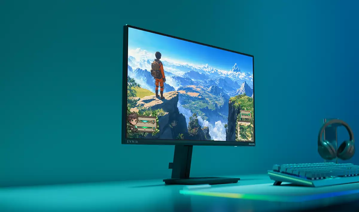Ein Gaming-Monitor zeigt eine Landschaftsszene. Tastatur und Kopfhörer sind sichtbar, mit türkisem Hintergrund.