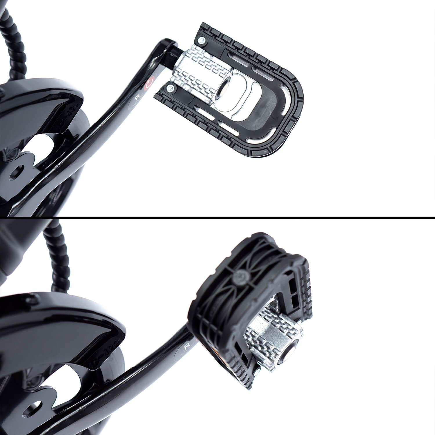 Primer plano de un pedal de bicicleta negro con eje plateado. El pedal es rectangular con superficie texturizada. El fondo es blanco.