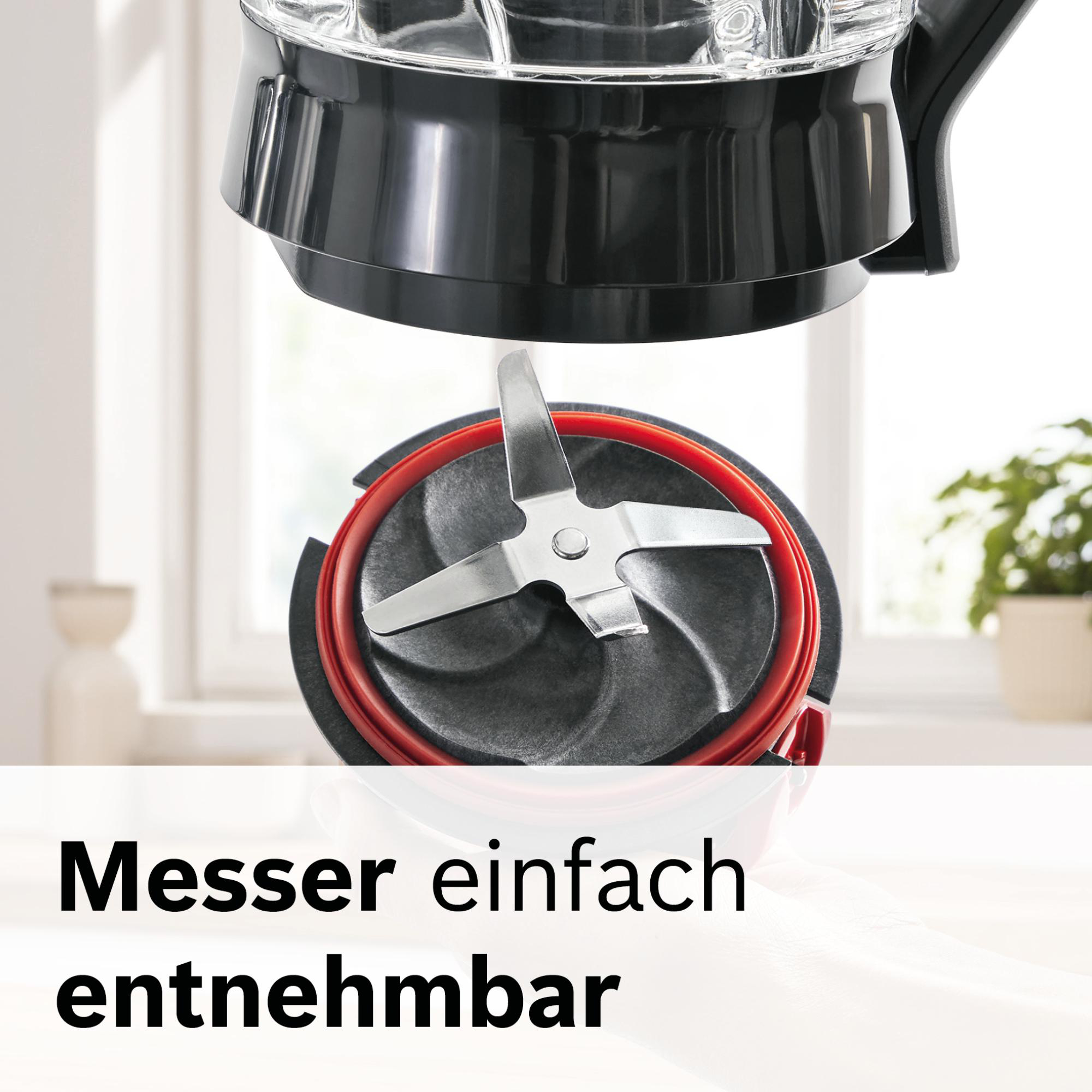Nahaufnahme einer Mixerklingenbaugruppe. Edelstahlklinge befindet sich über einer dunkelgrauen und roten Komponente. Text sagt: "Messer einfach entnehmbar".