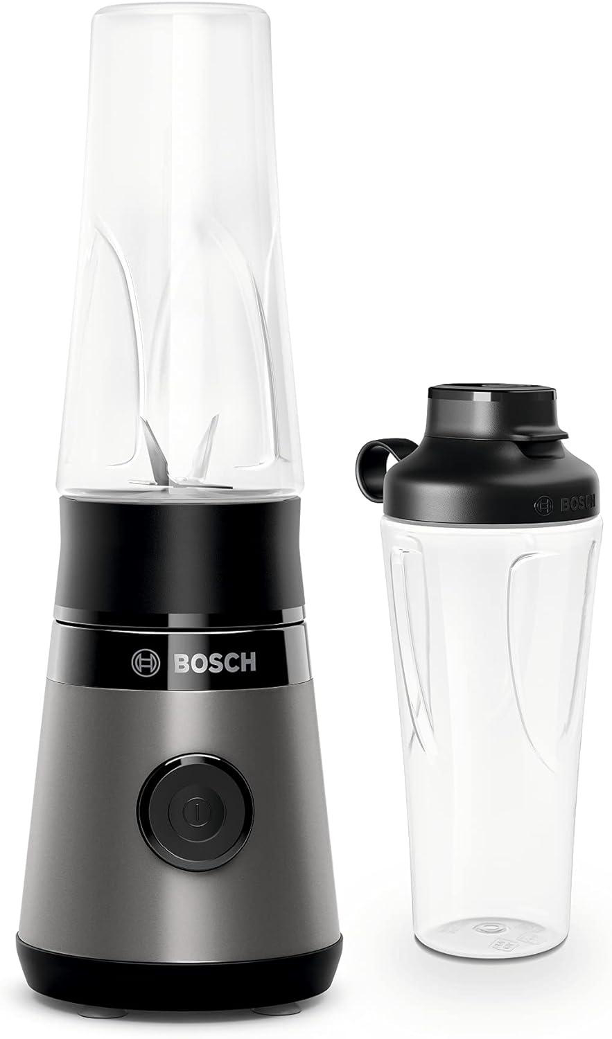 Ein Bosch-Mixer mit zwei durchsichtigen Plastikbechern, einer auf der Basis und einer separat. Die Basis ist grau, mit dem Bosch-Logo.