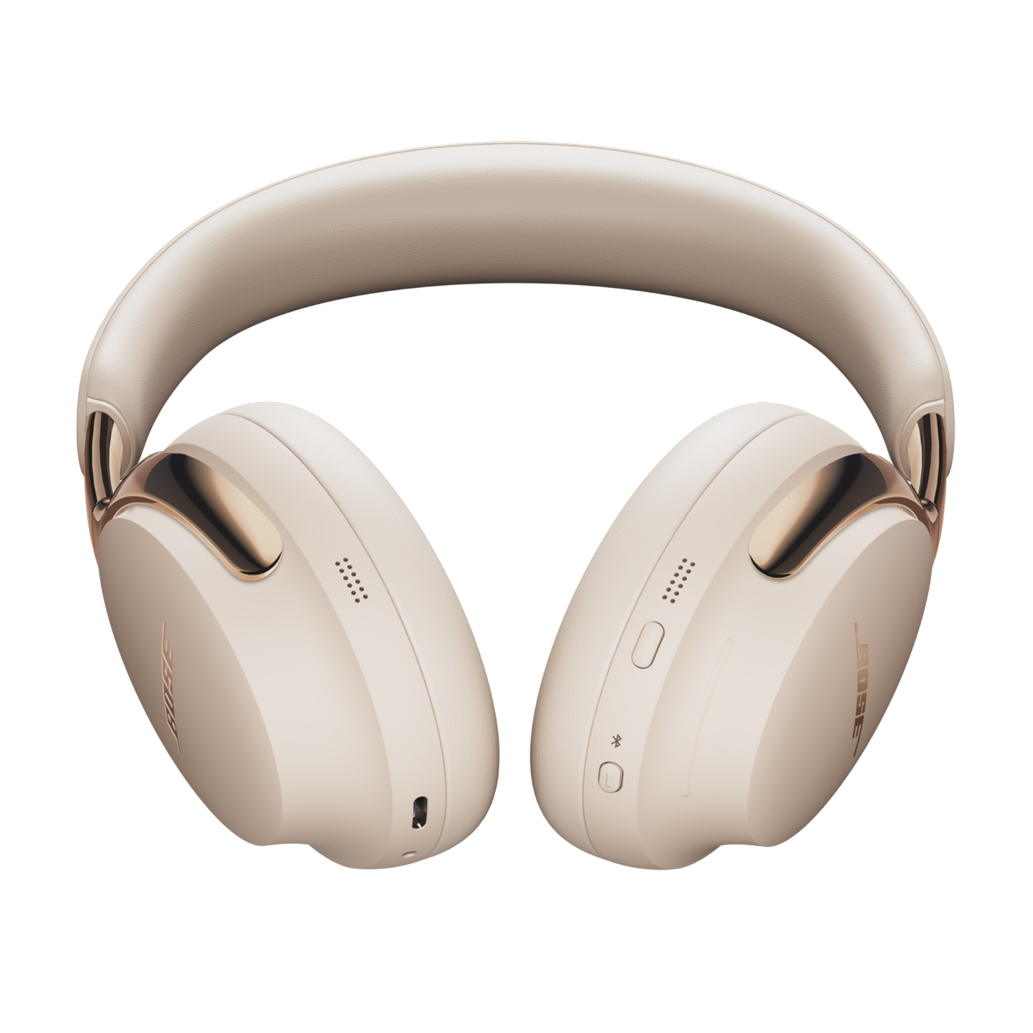 Cuffie Bose beige con dettagli dorati, isolate su bianco. Le cuffie hanno una fascia imbottita e padiglioni auricolari con il logo Bose.