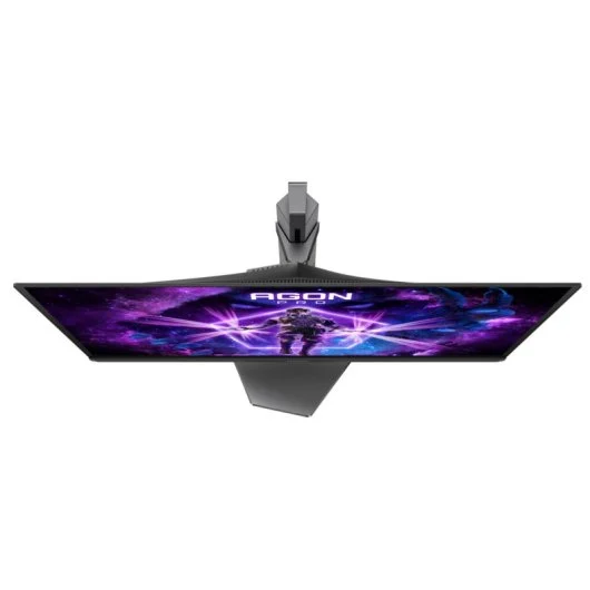 Vista superior de un monitor gaming. La pantalla muestra un gráfico morado y azul. El soporte es gris oscuro. El fondo es blanco.