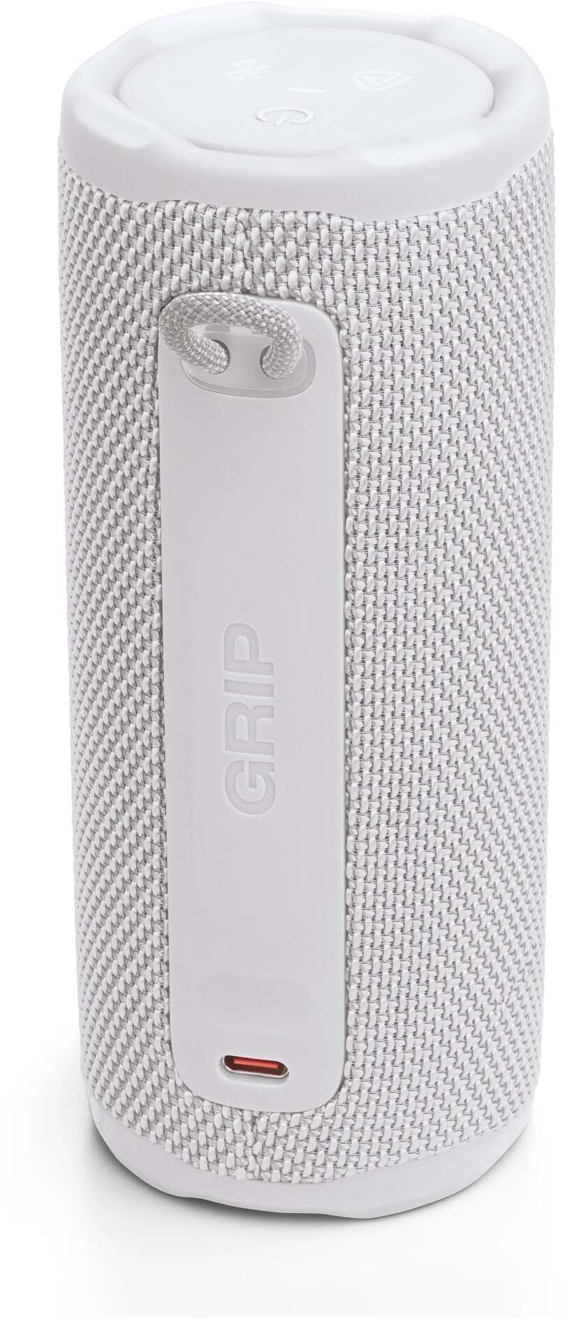 Biały głośnik z teksturowaną powierzchnią, białym uchwytem z napisem 'GRIP' i czerwonym portem ładowania.