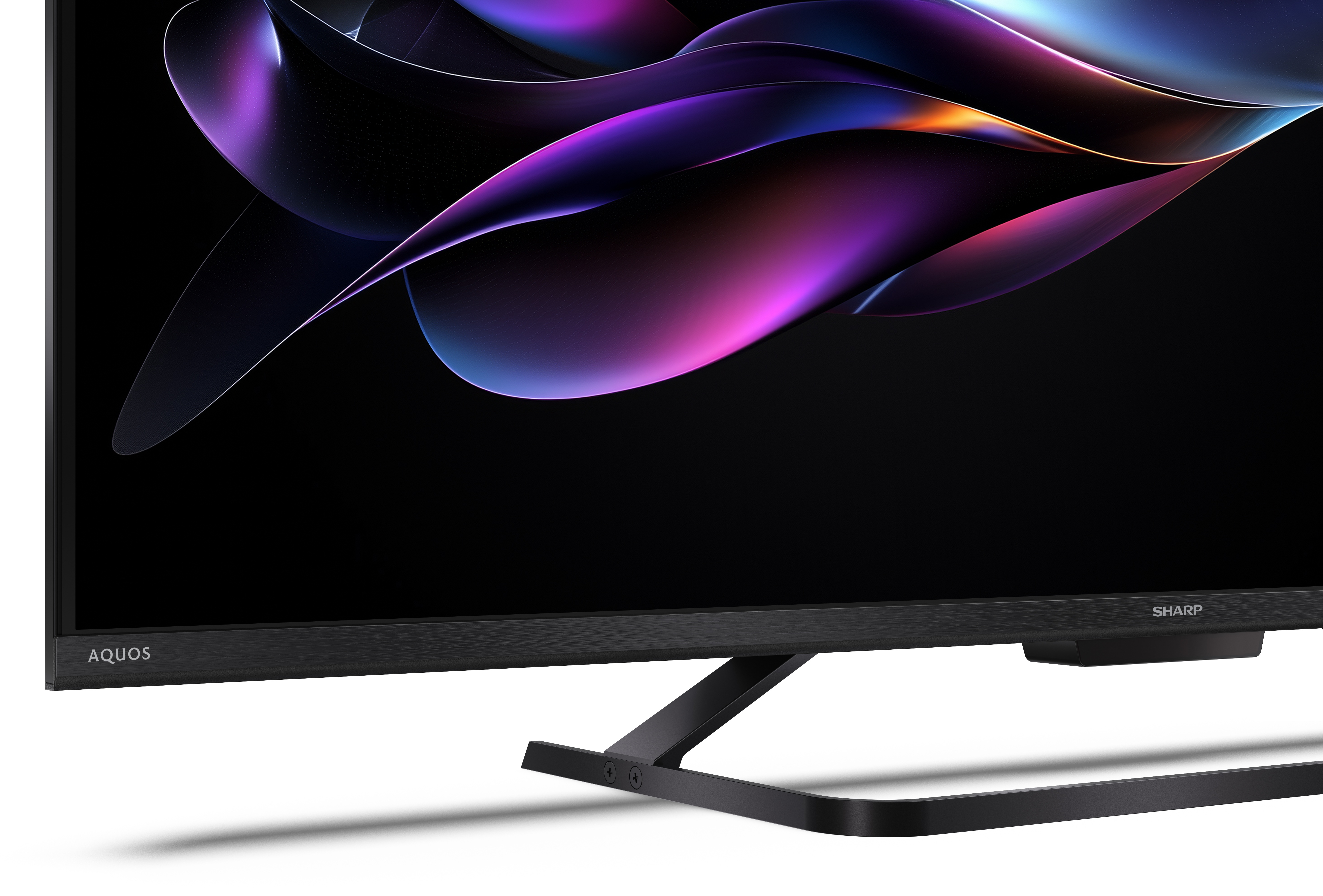 Czarny telewizor Sharp Aquos z kolorowym, abstrakcyjnym wzorem na ekranie i czarnym tłem.